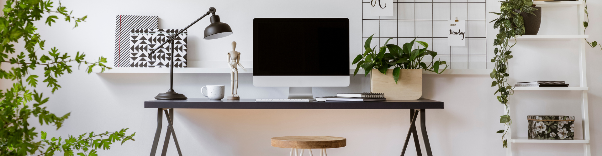 A desk with a computer and lamp.