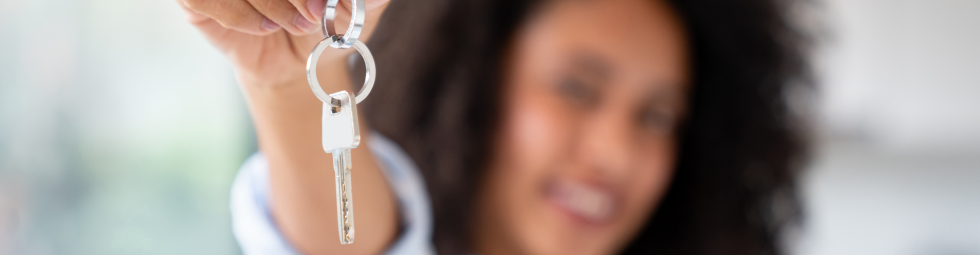 A woman holding a key.