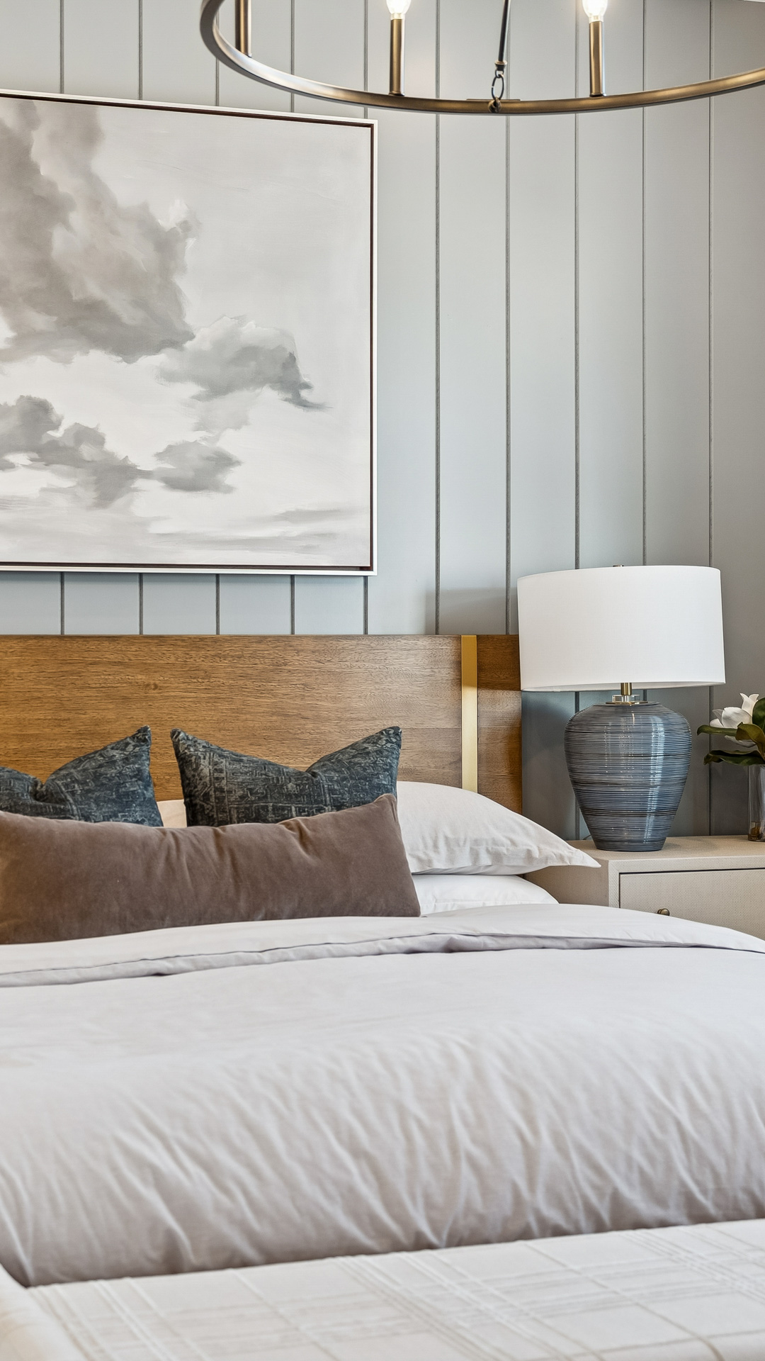 Champlain Model home in Willow at Teravalis primary suite with editorial accents with fluffy bed, table lamp, contrast wall, nice end tables, model home in Buckeye AZ New Homes for sale and new construction in buckeye AZ.