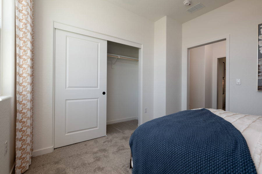 A room with a bed and a door.