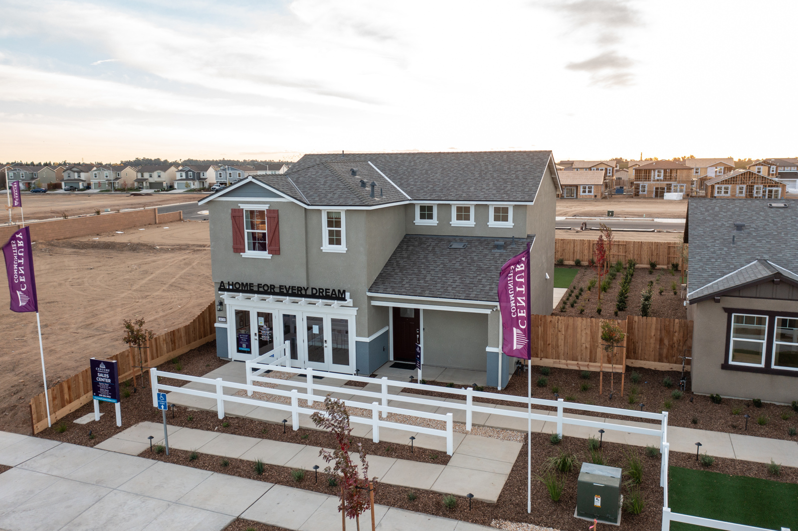 A white house with a fence around it.