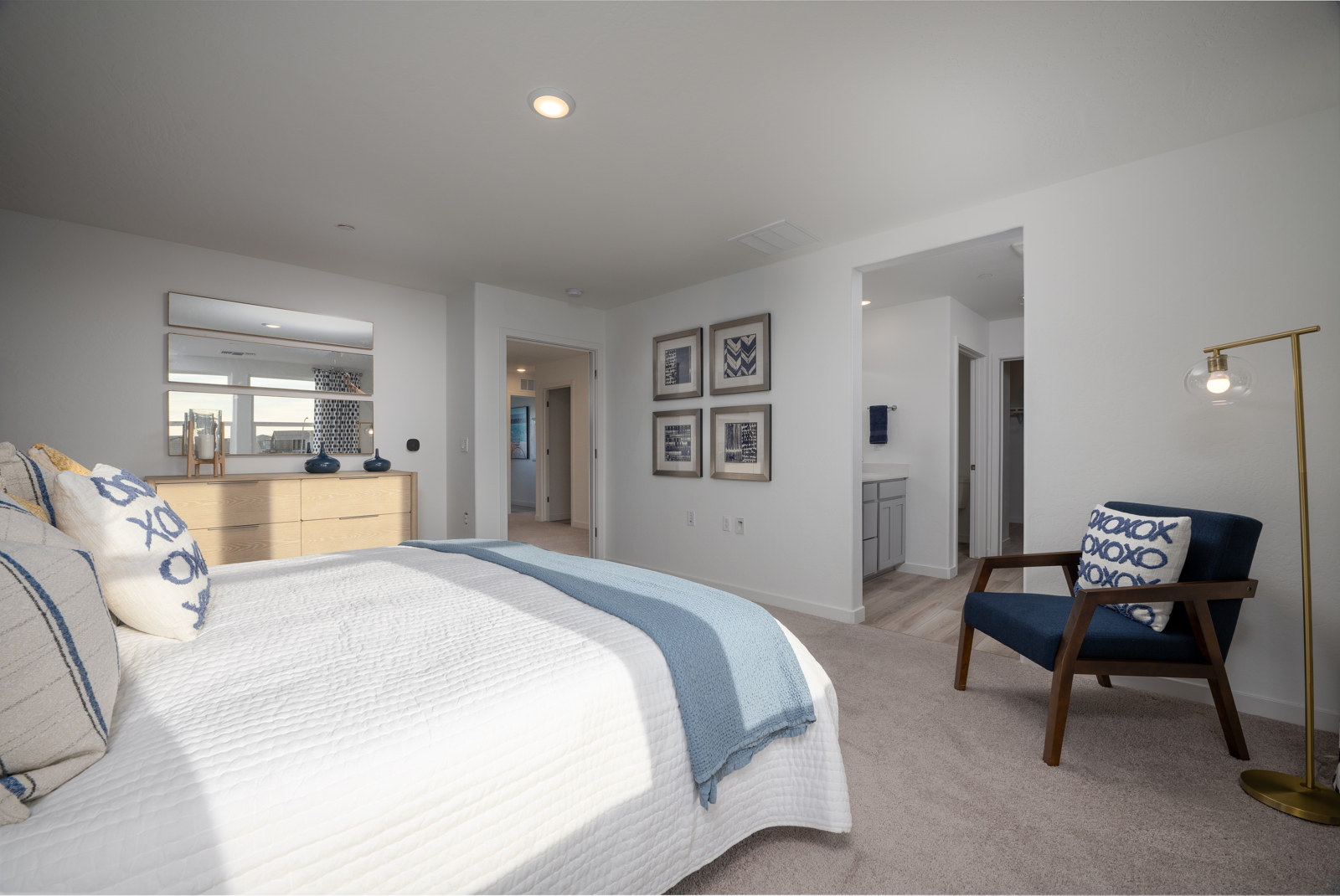 A bedroom with a bed and a chair.