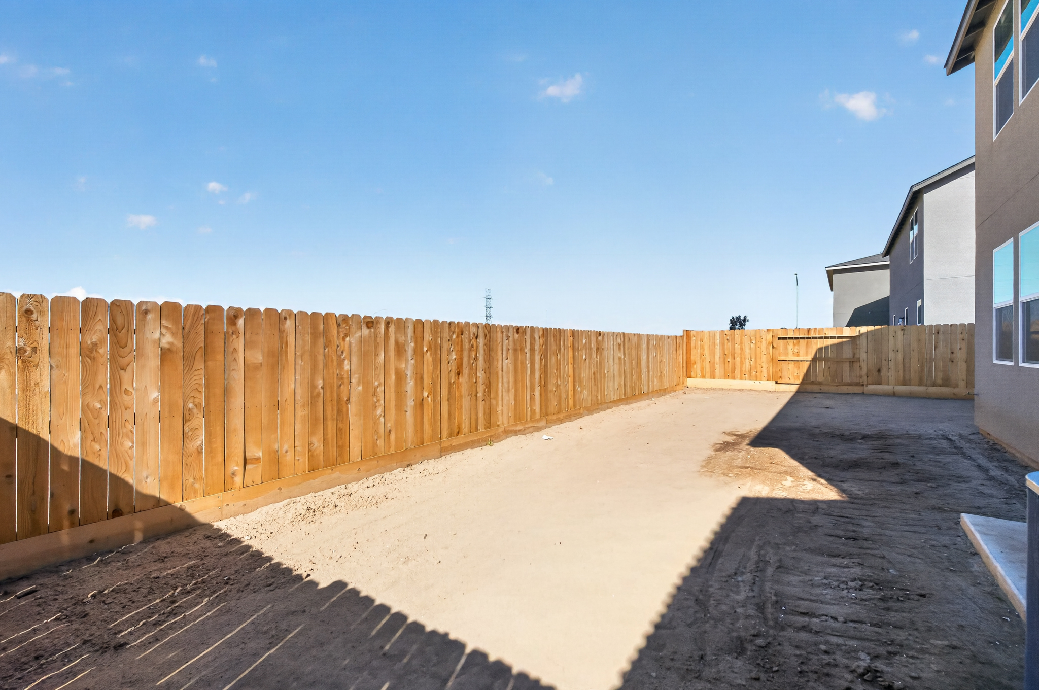 A wooden fence next to a building.
