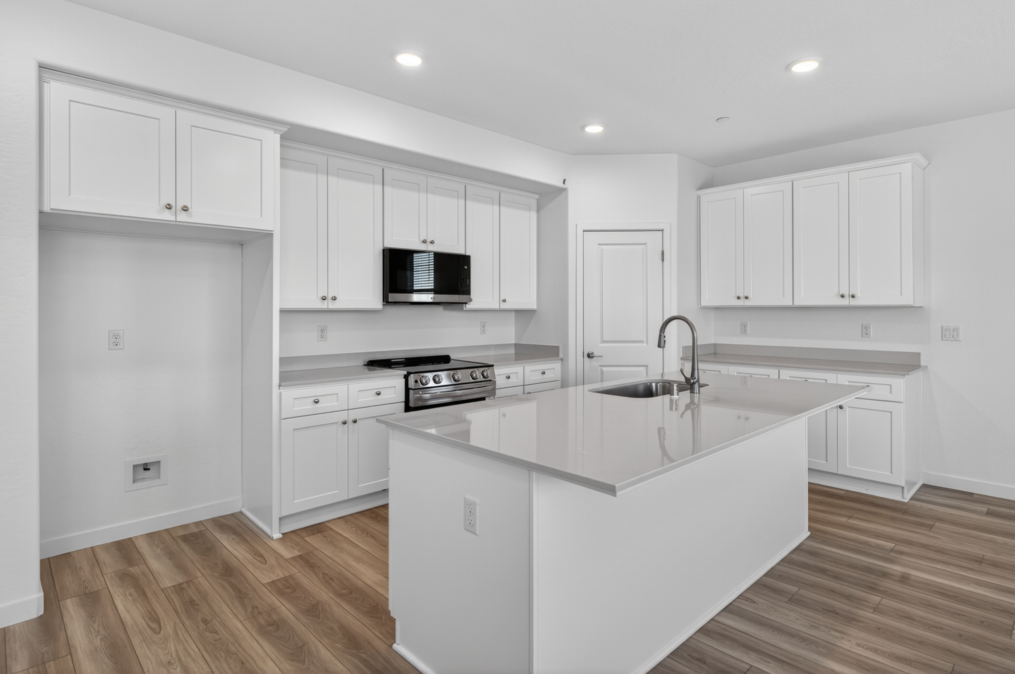 A kitchen with white cabinets.