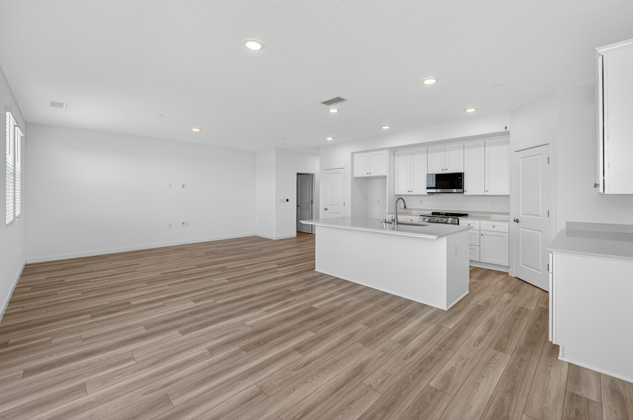 A kitchen with white cabinets.