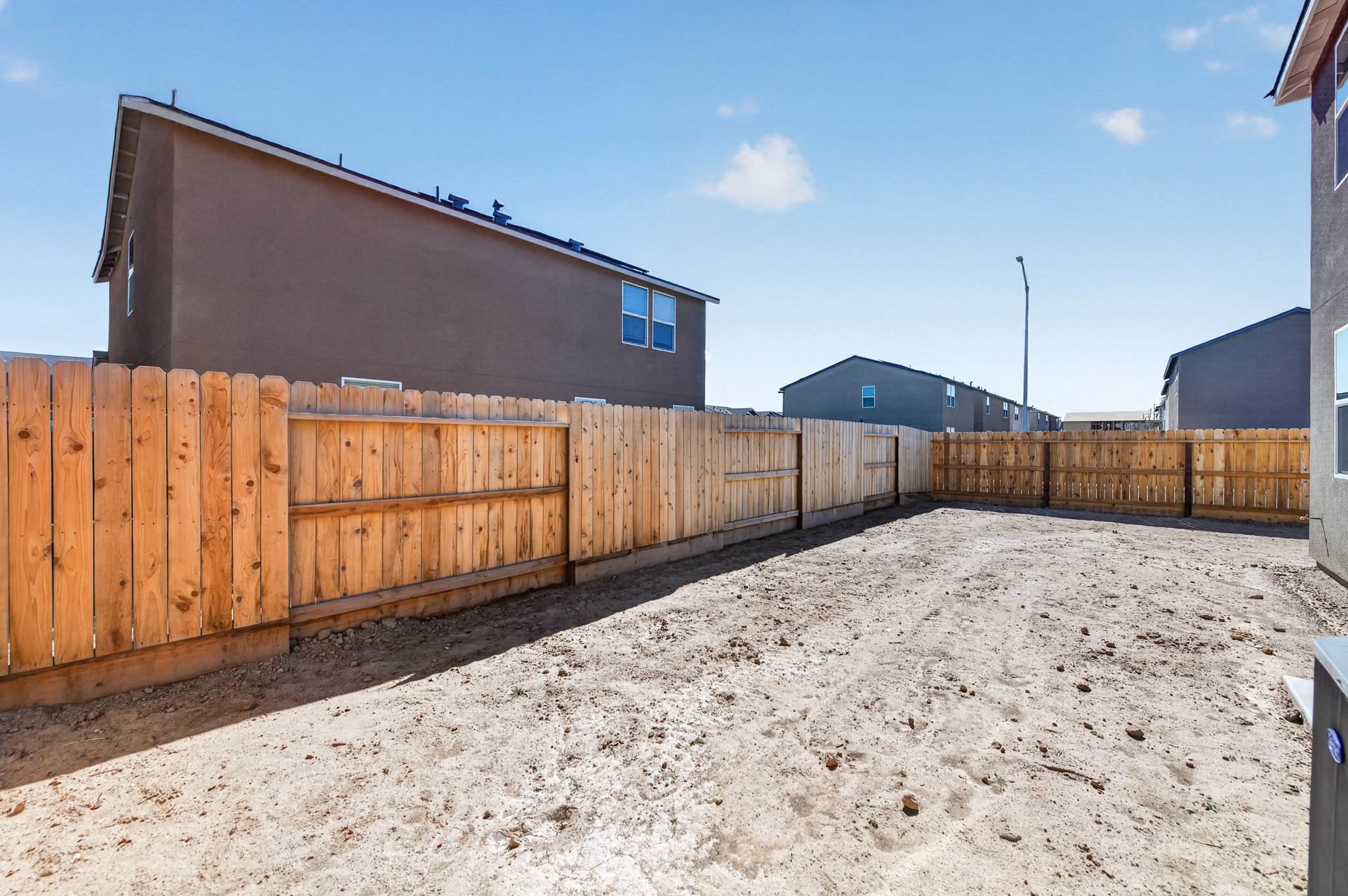 A fenced in area with a building in the background.