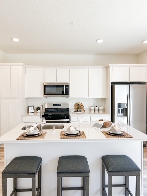 A kitchen with white cabinets.