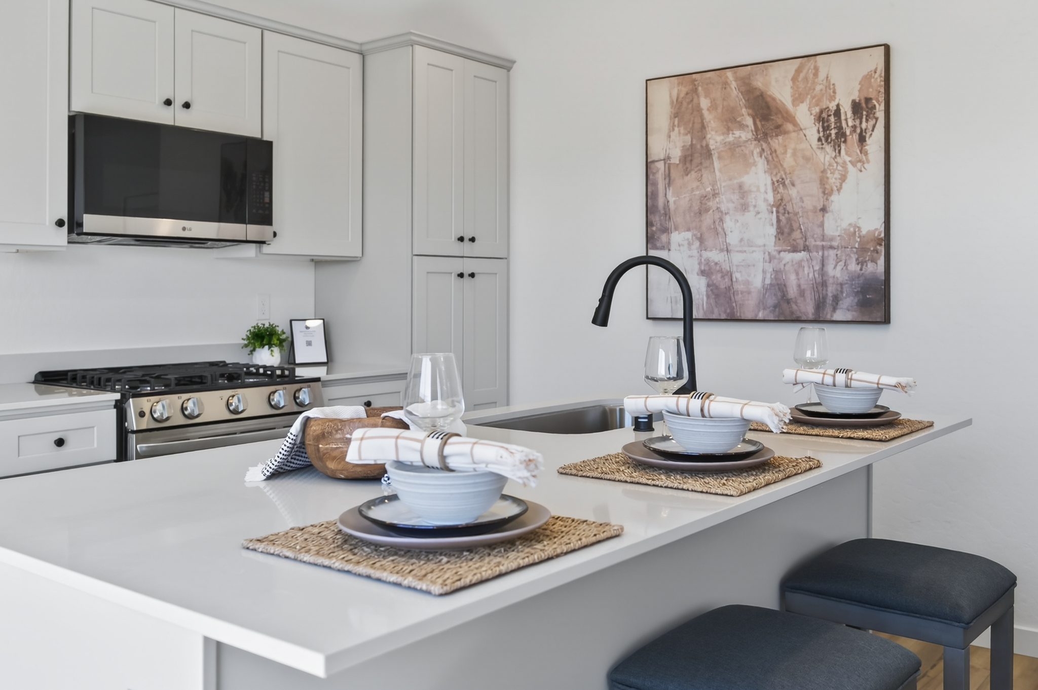 A kitchen with white cabinets.