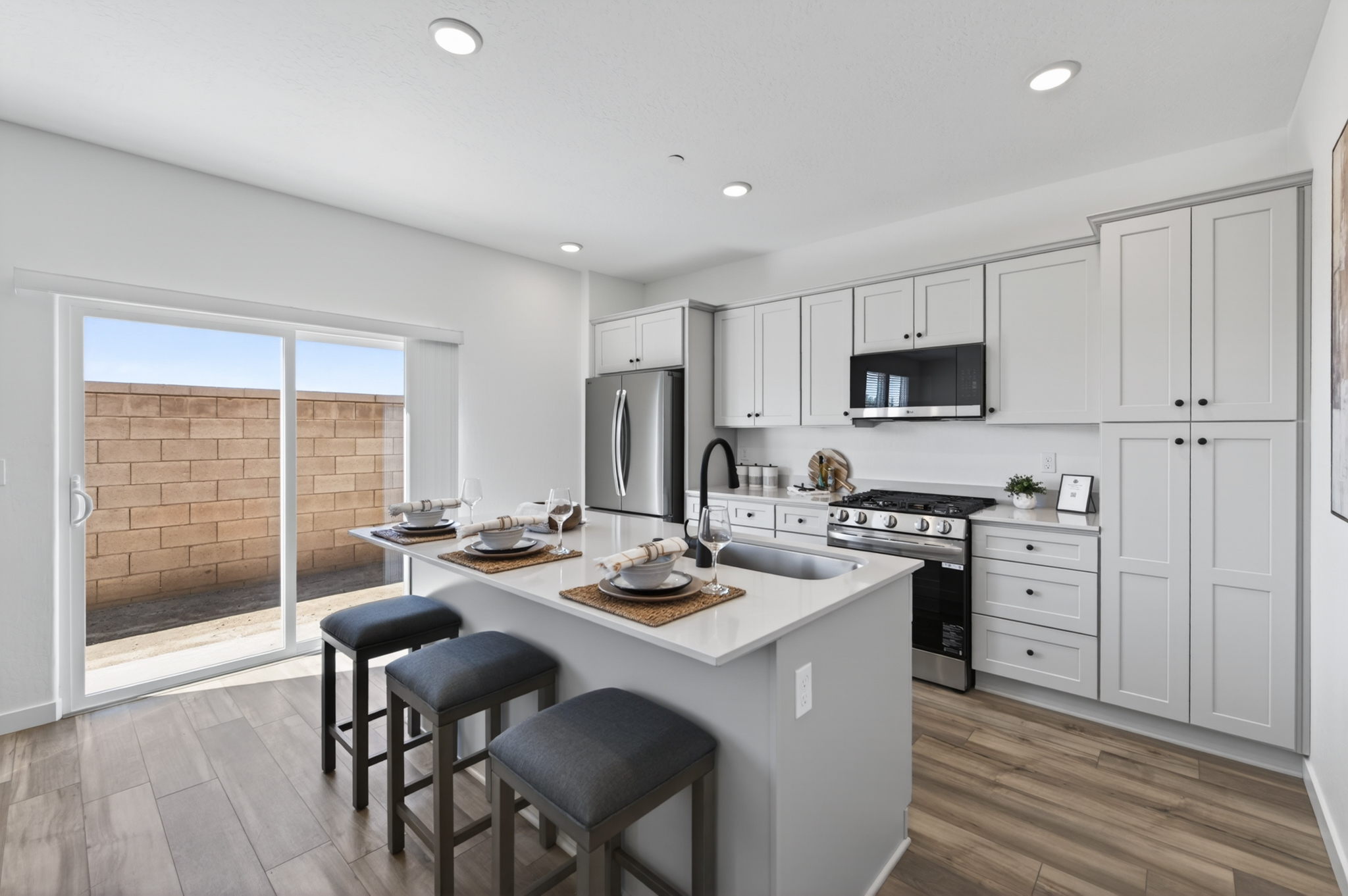 A kitchen with white cabinets.