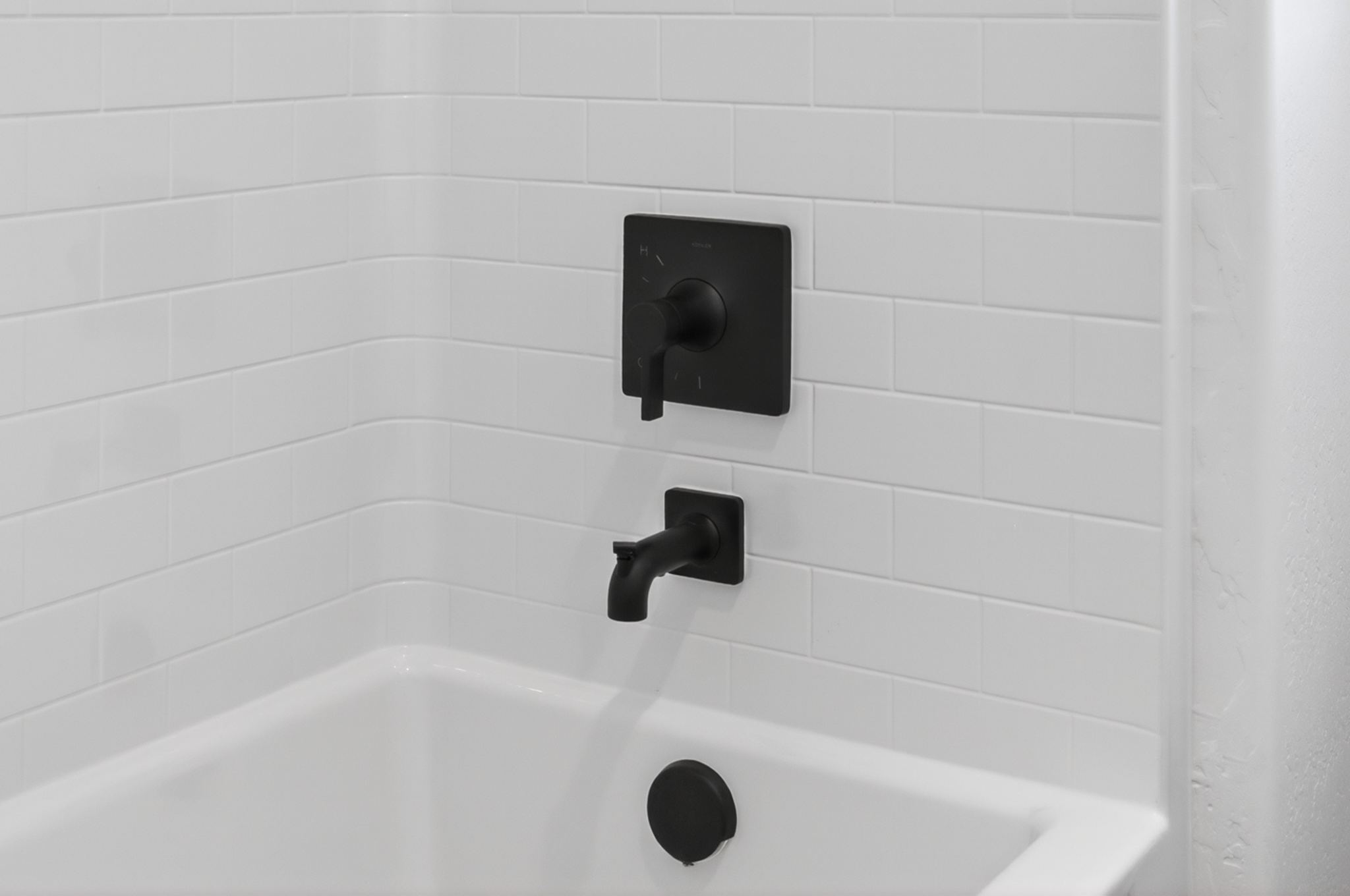 A bathtub with a light switch.