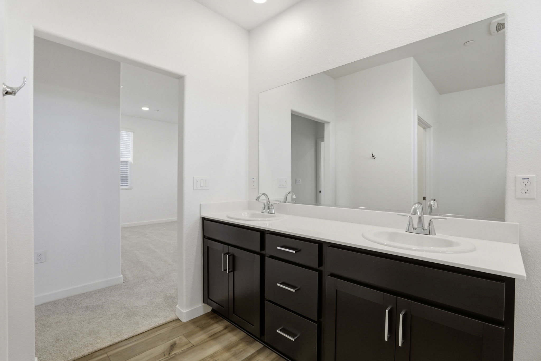 A bathroom with a large mirror.