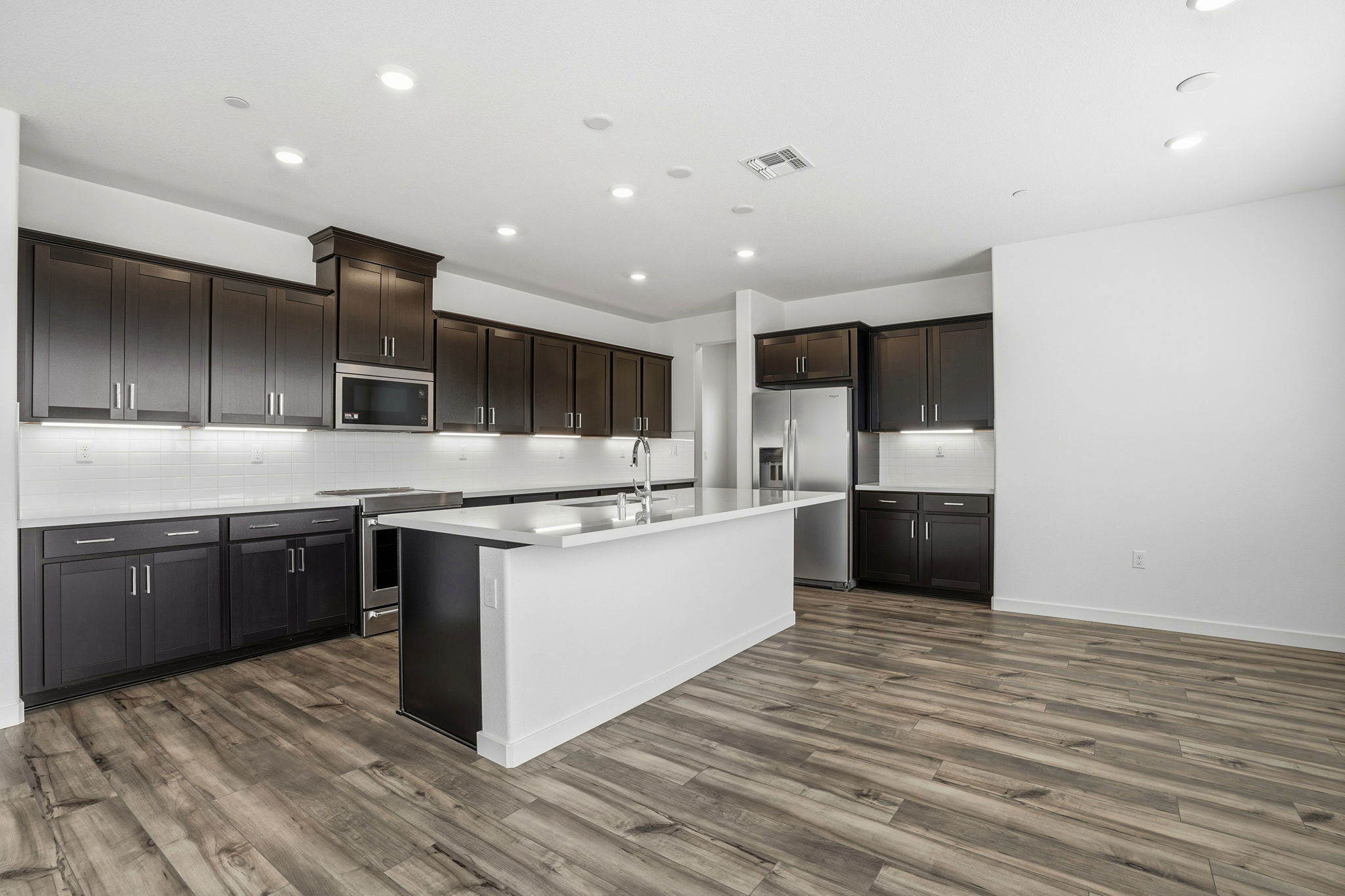 A kitchen with black cabinets.