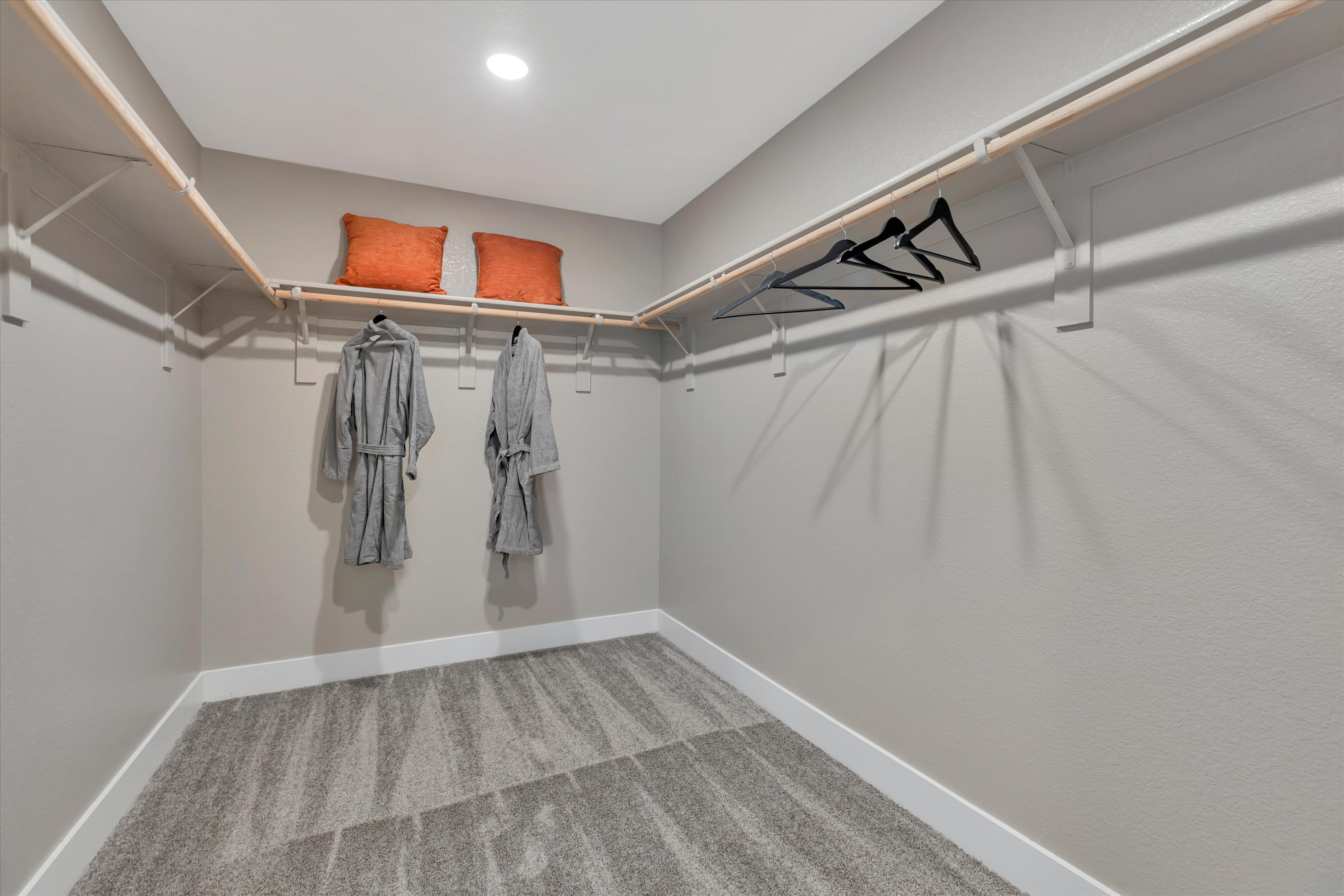 A white room with a white wall and a white floor with a couple of towels on the.