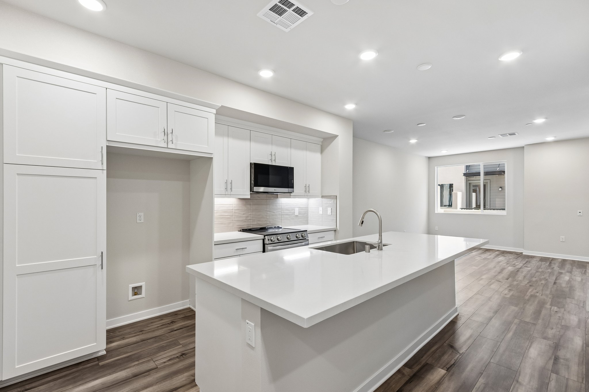 A kitchen with white cabinets.