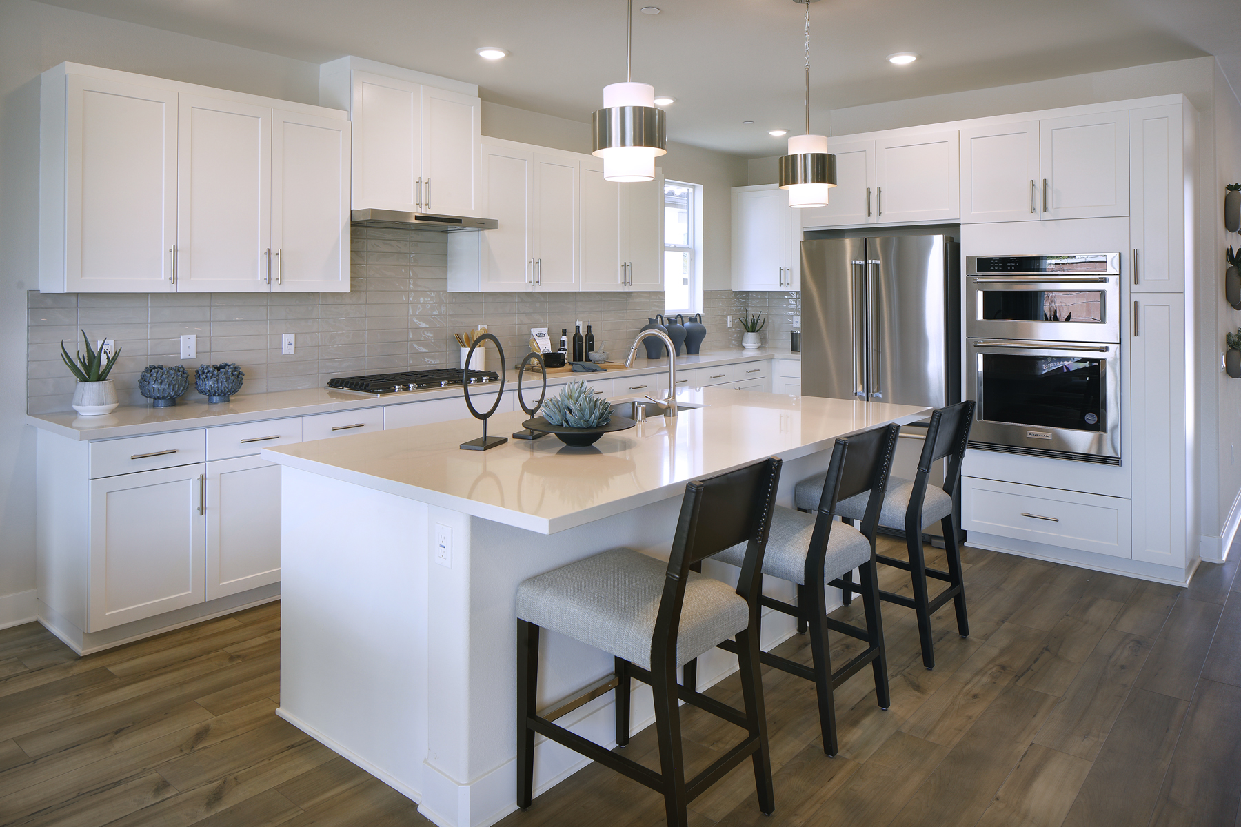 A kitchen with white cabinets.