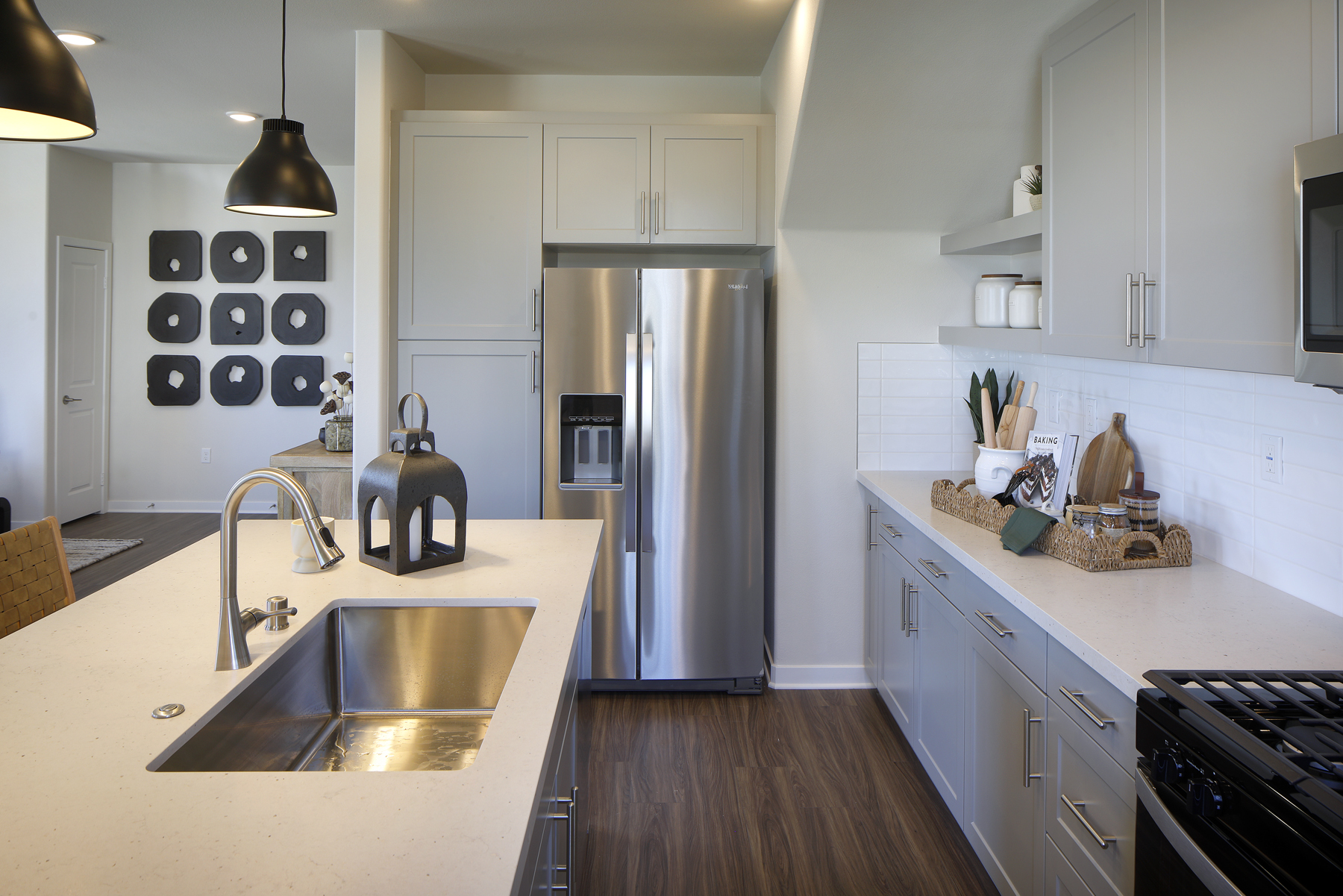 A kitchen with white cabinets.