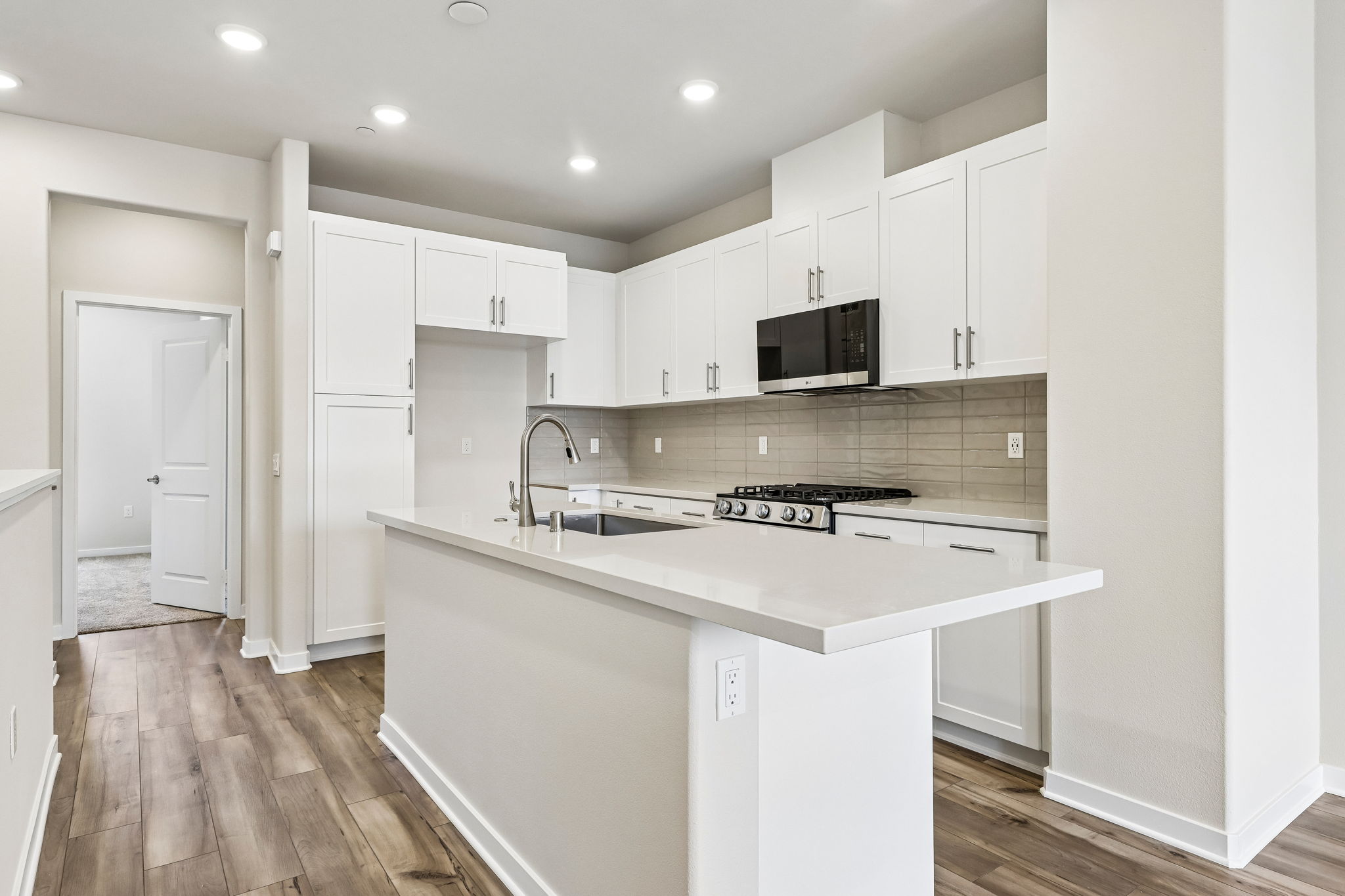 A kitchen with white cabinets.
