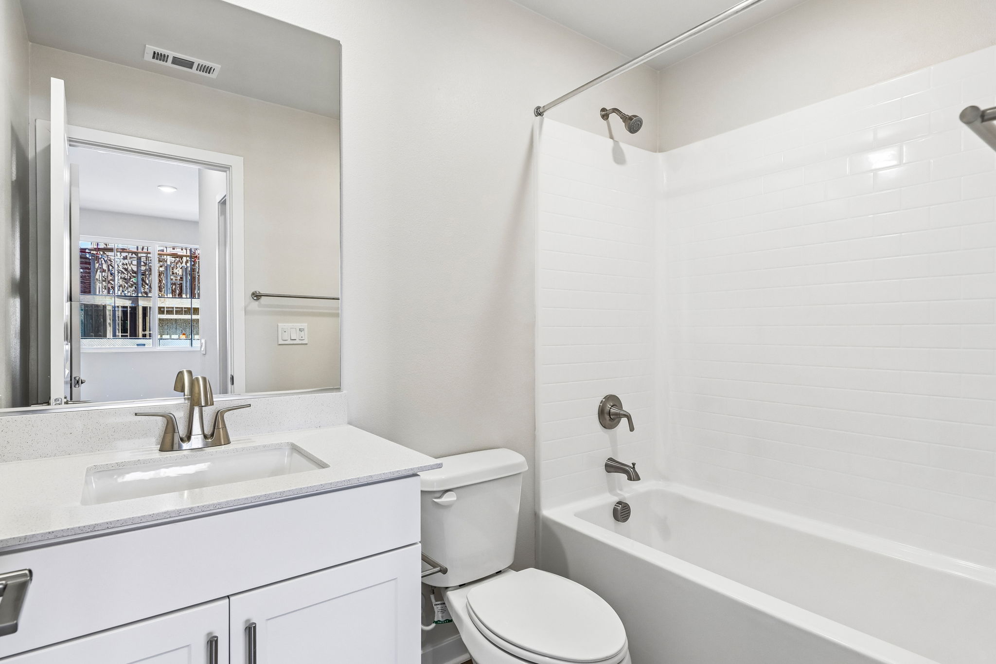 A bathroom with a tub sink and toilet.