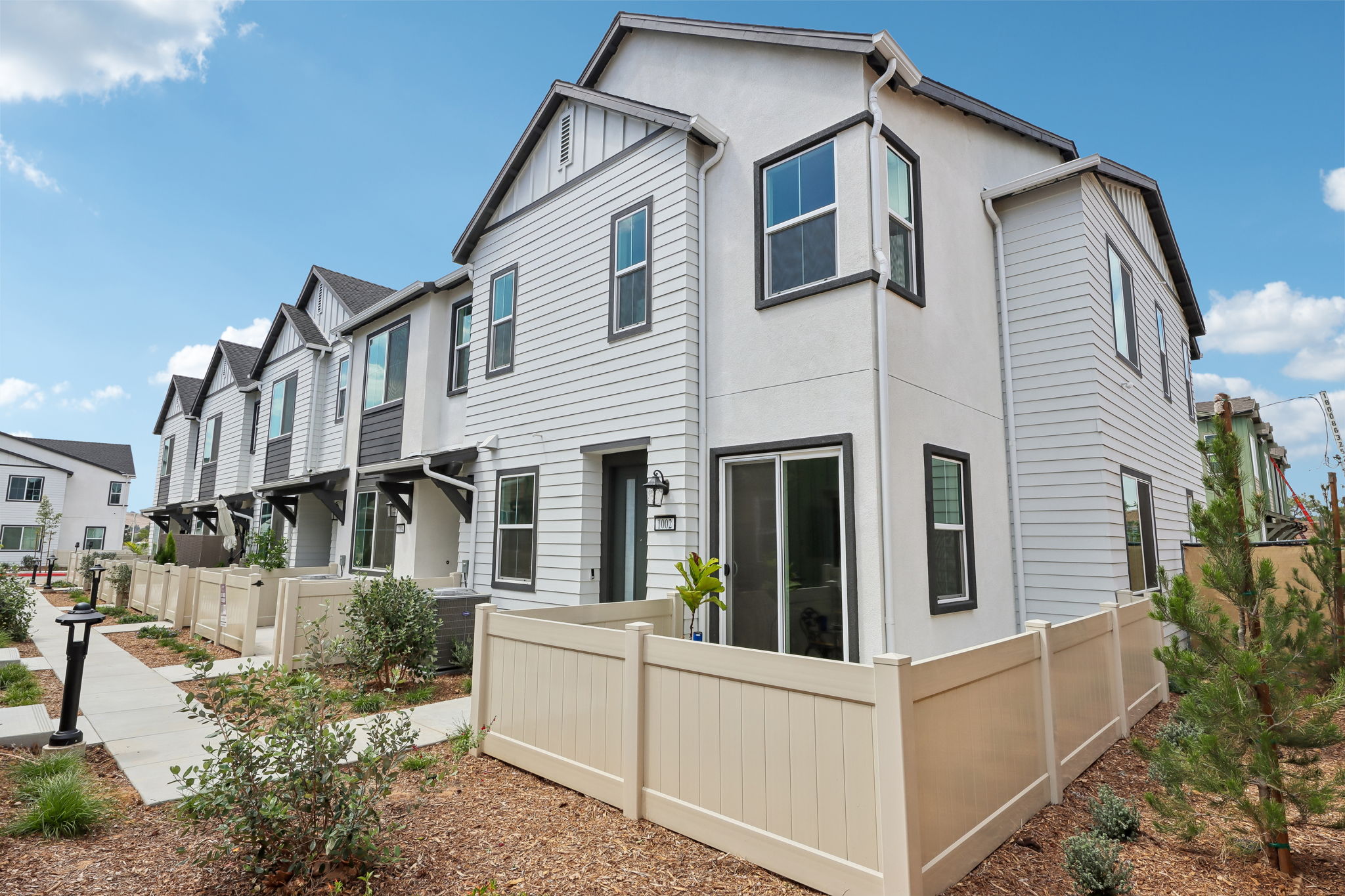 A white house with a fence.