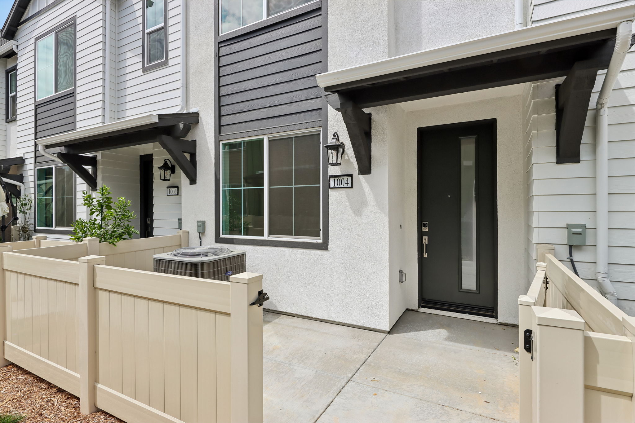 A white house with a white fence.