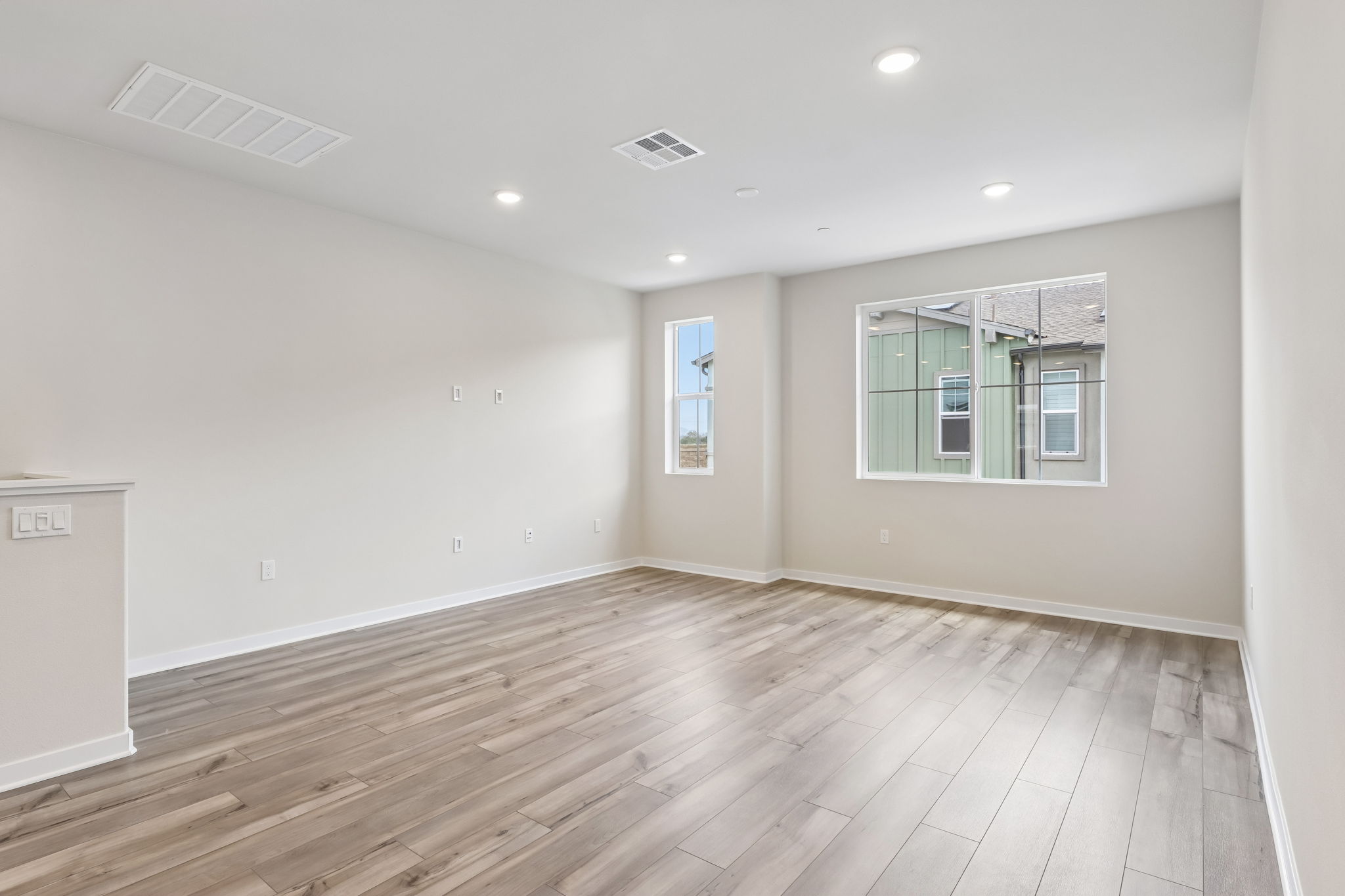 A room with a wood floor and a window.