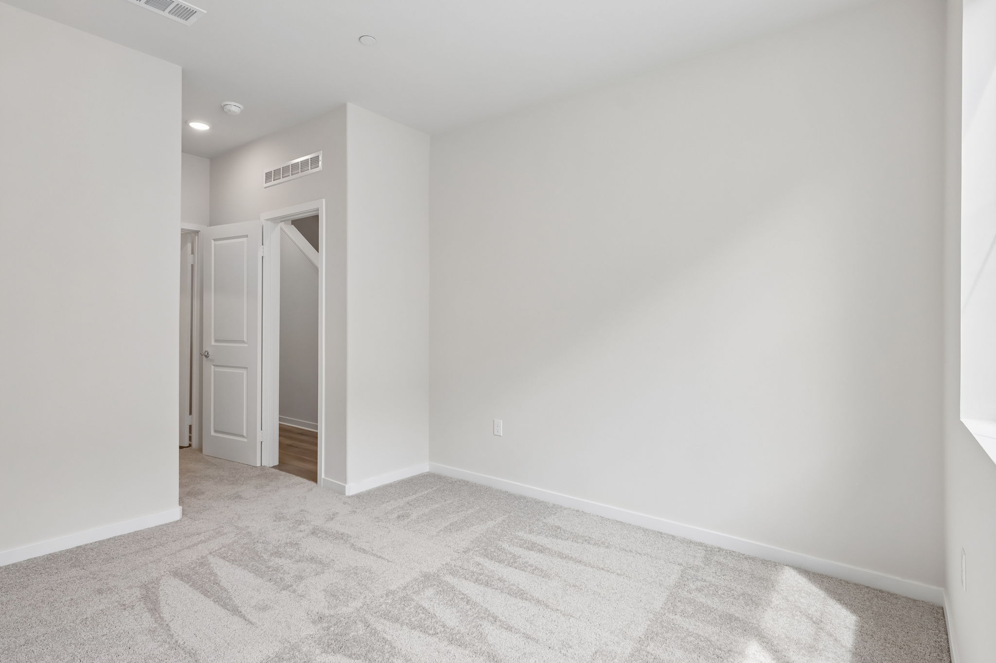 A hallway with white walls.