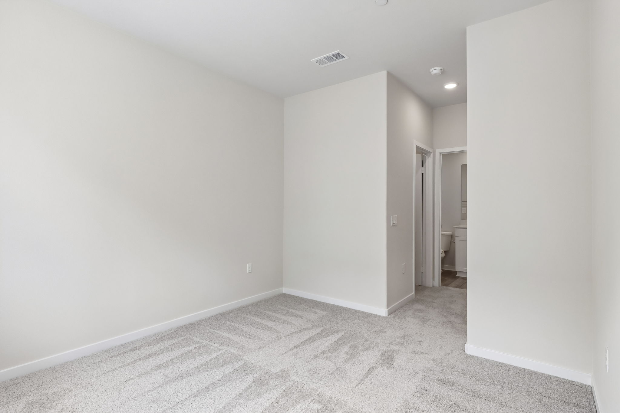 A hallway with white walls.