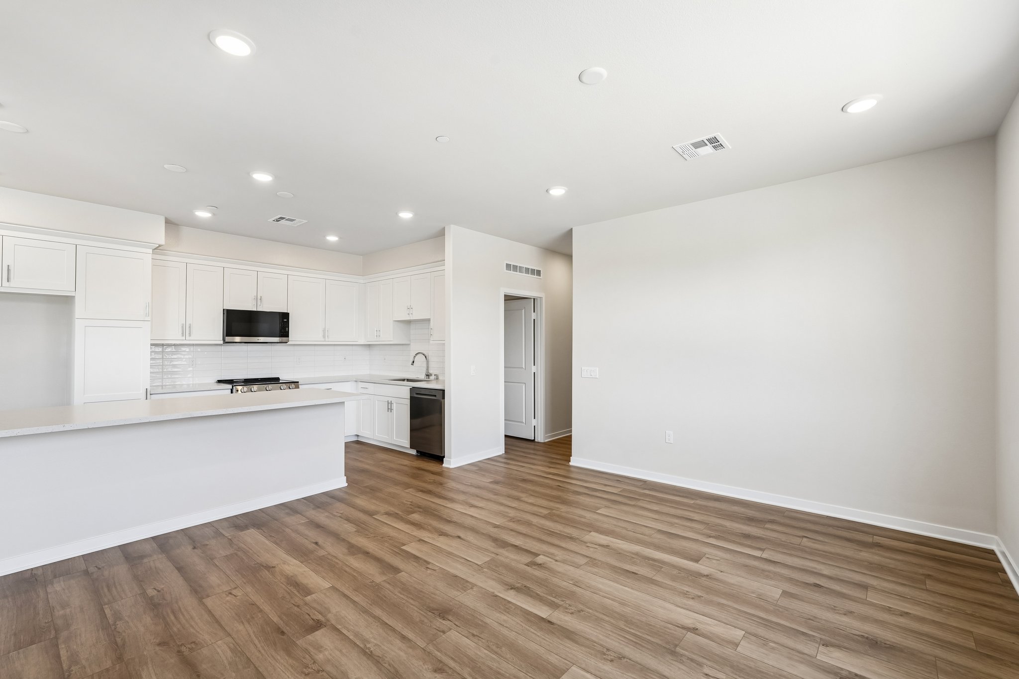 A large kitchen with white cabinets.