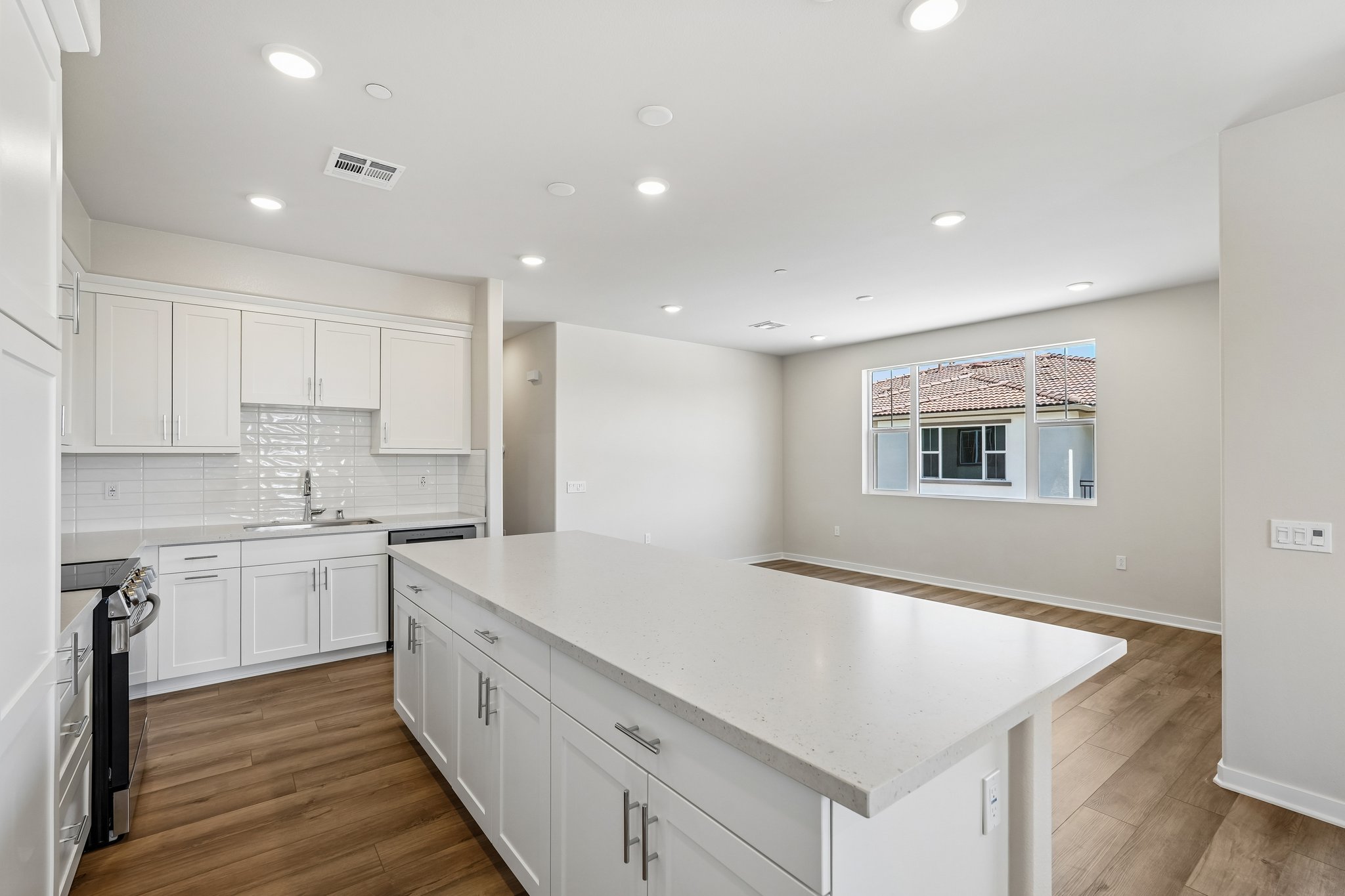 A kitchen with white cabinets.