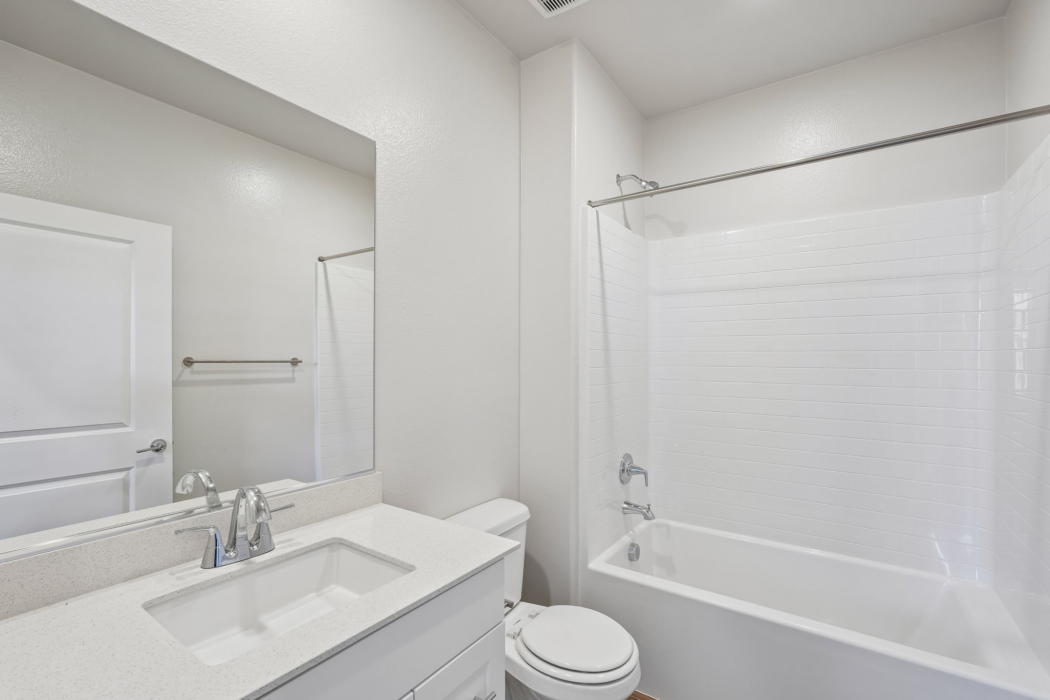 A bathroom with a tub sink and toilet.