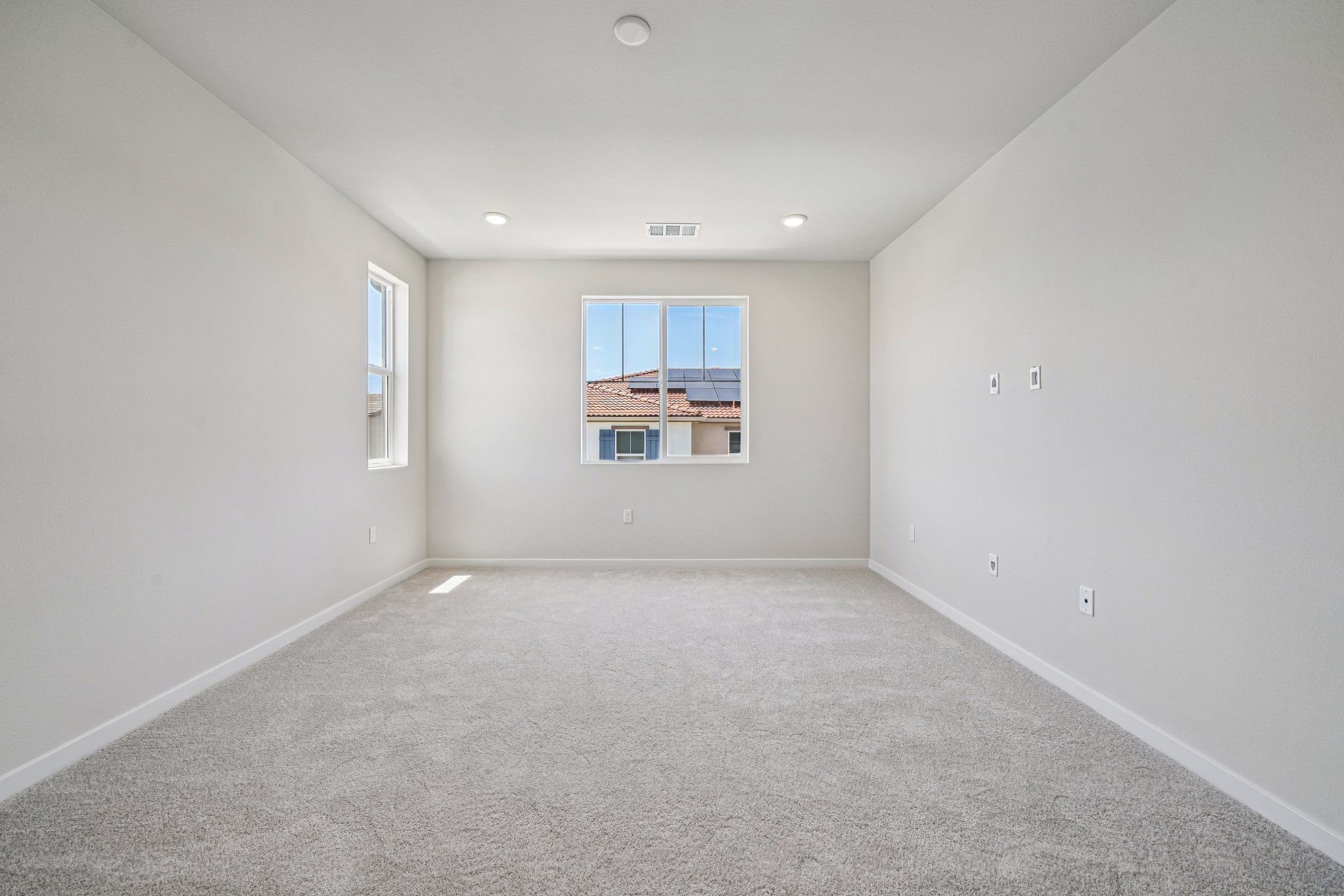 A room with a window and a carpet.