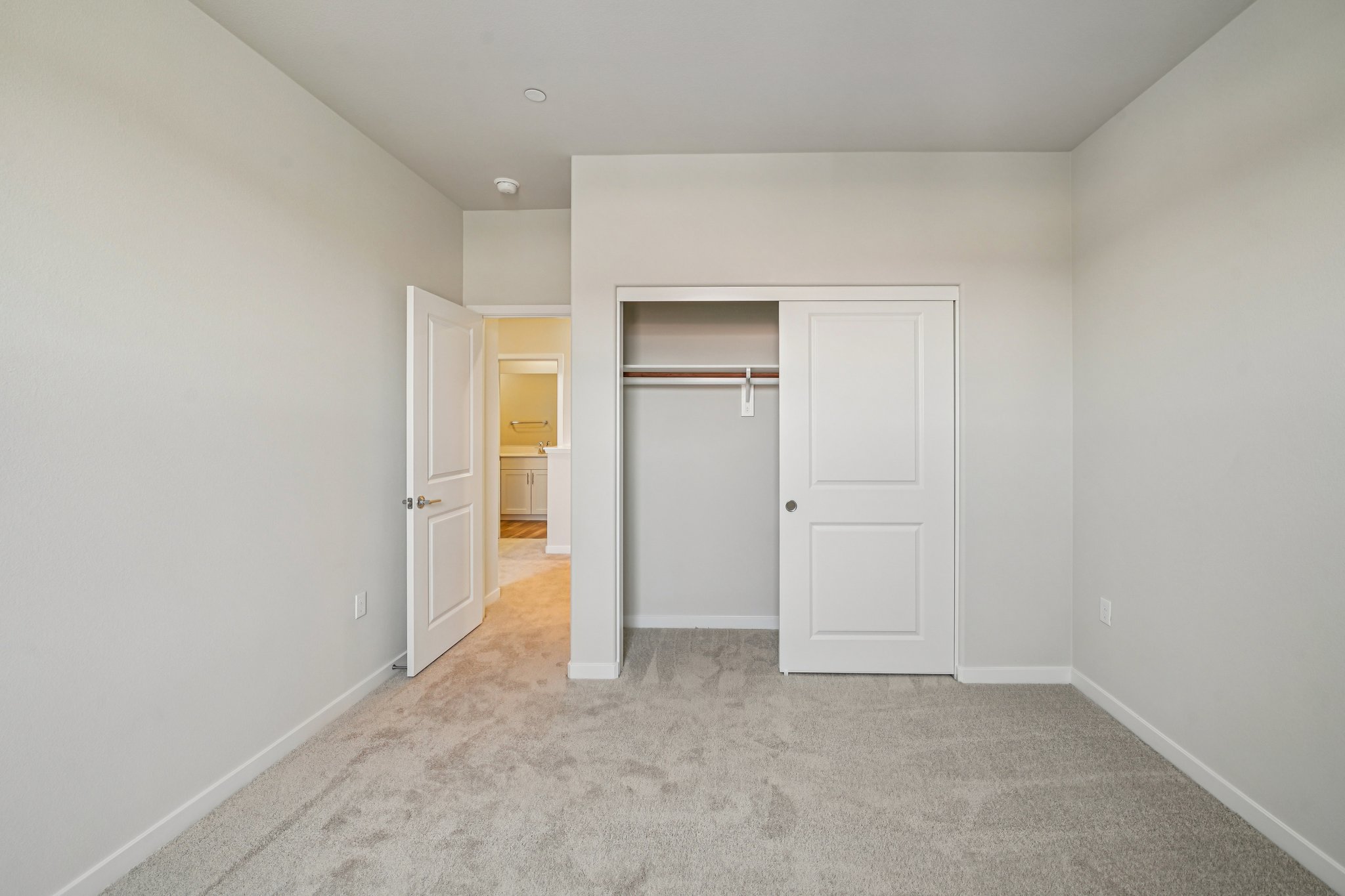 A hallway with white doors.