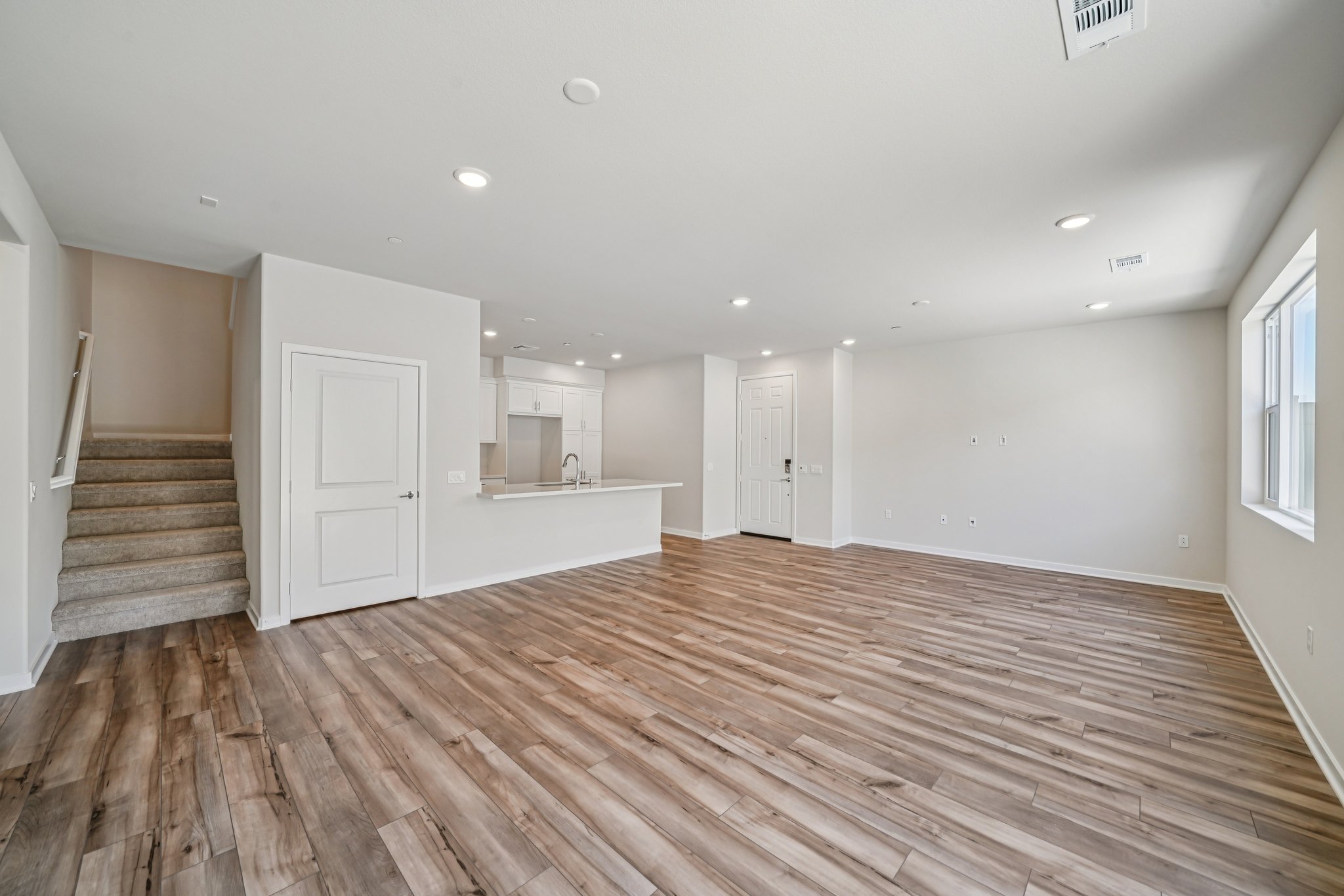 A large empty room with white doors.
