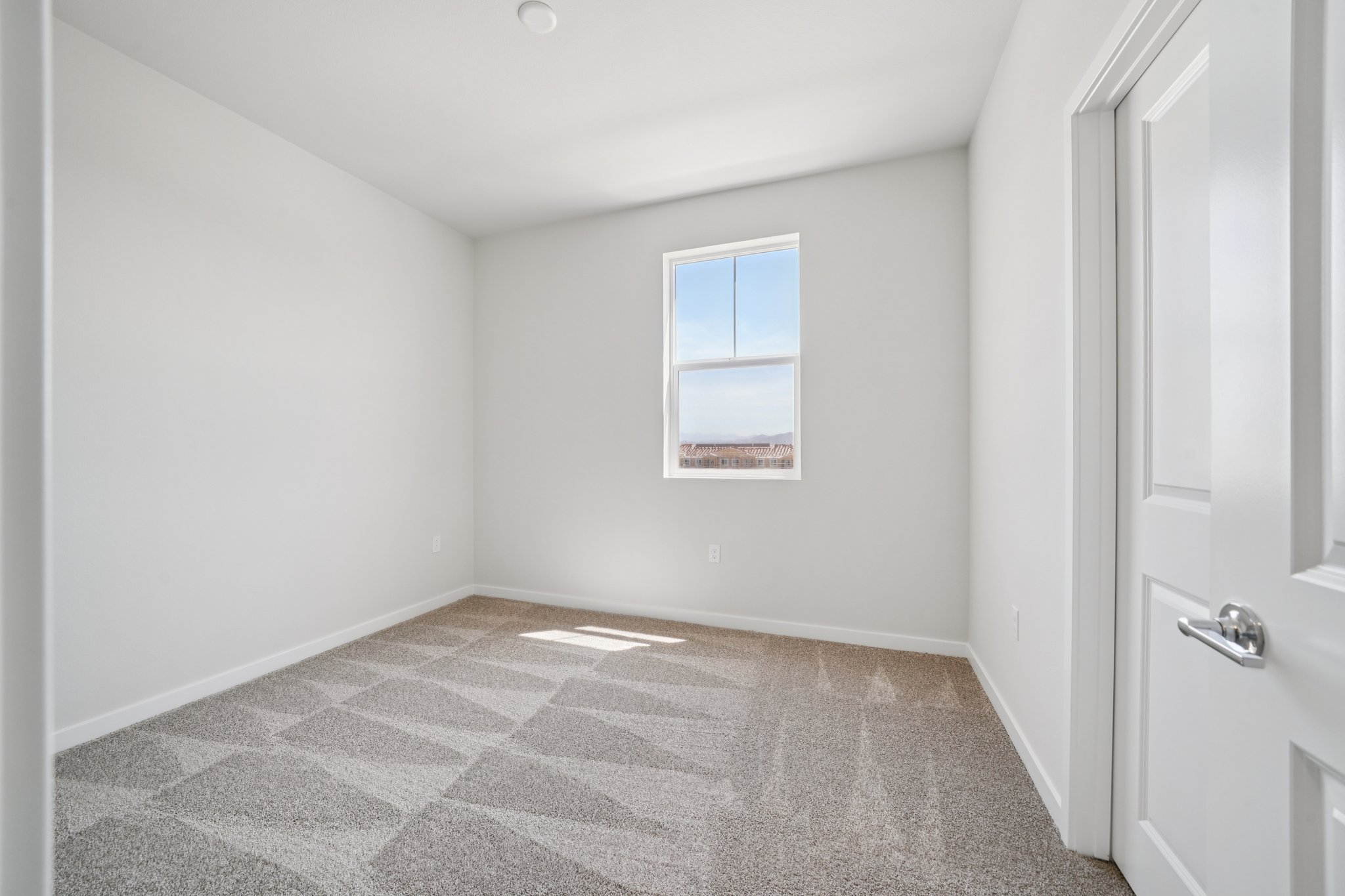 A room with a tile floor and a window.