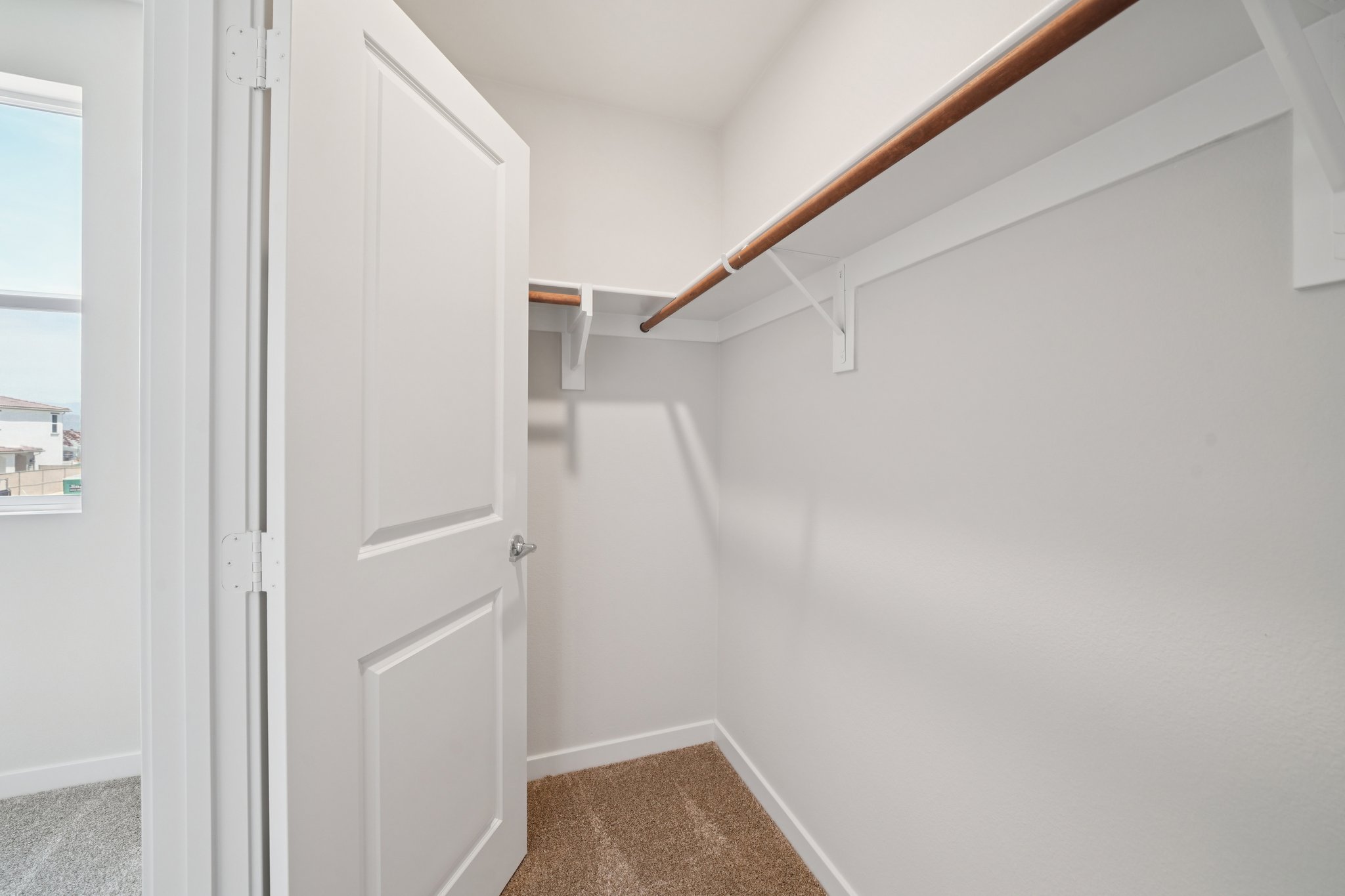 A white door with a wooden railing.