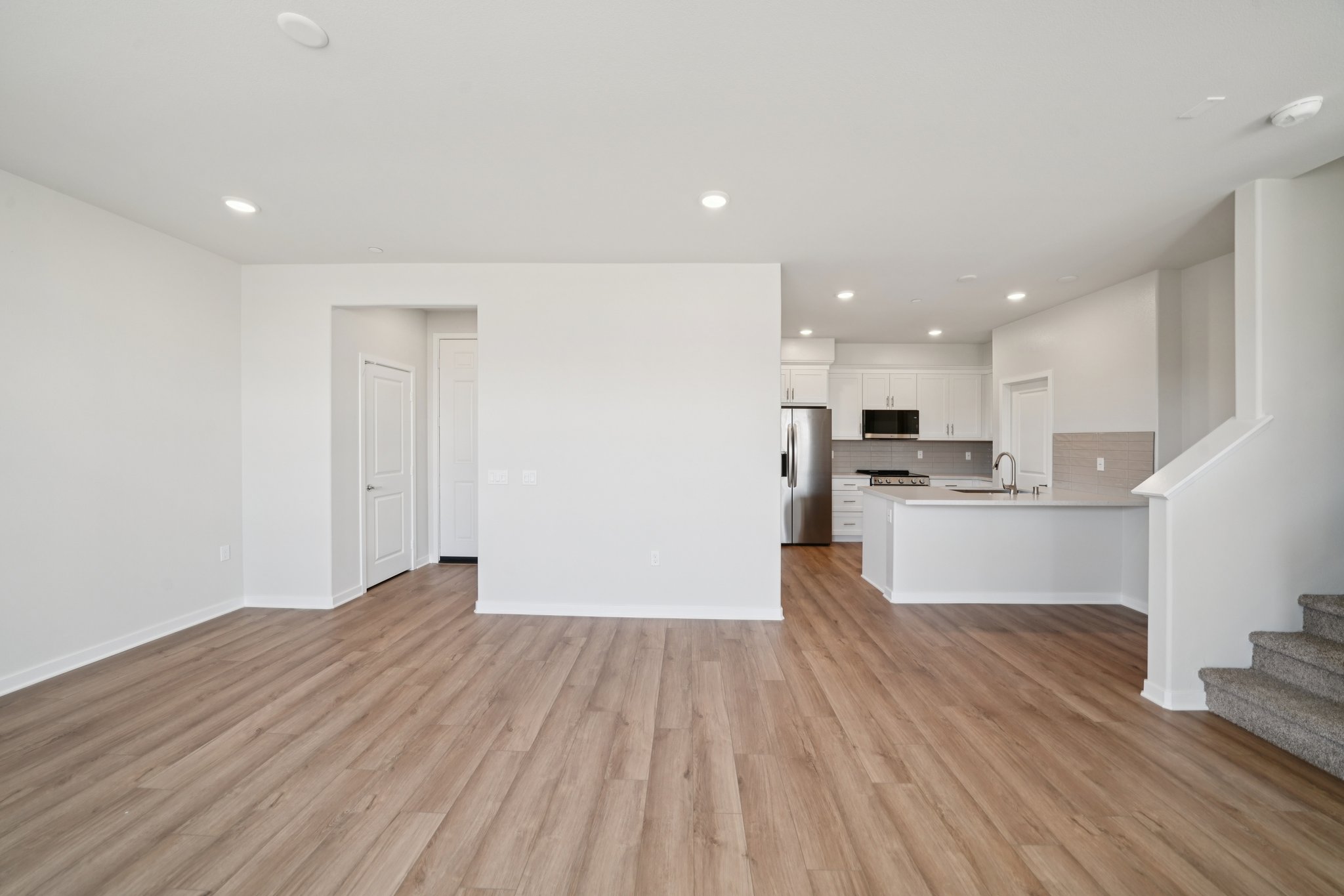 A large kitchen with white walls.