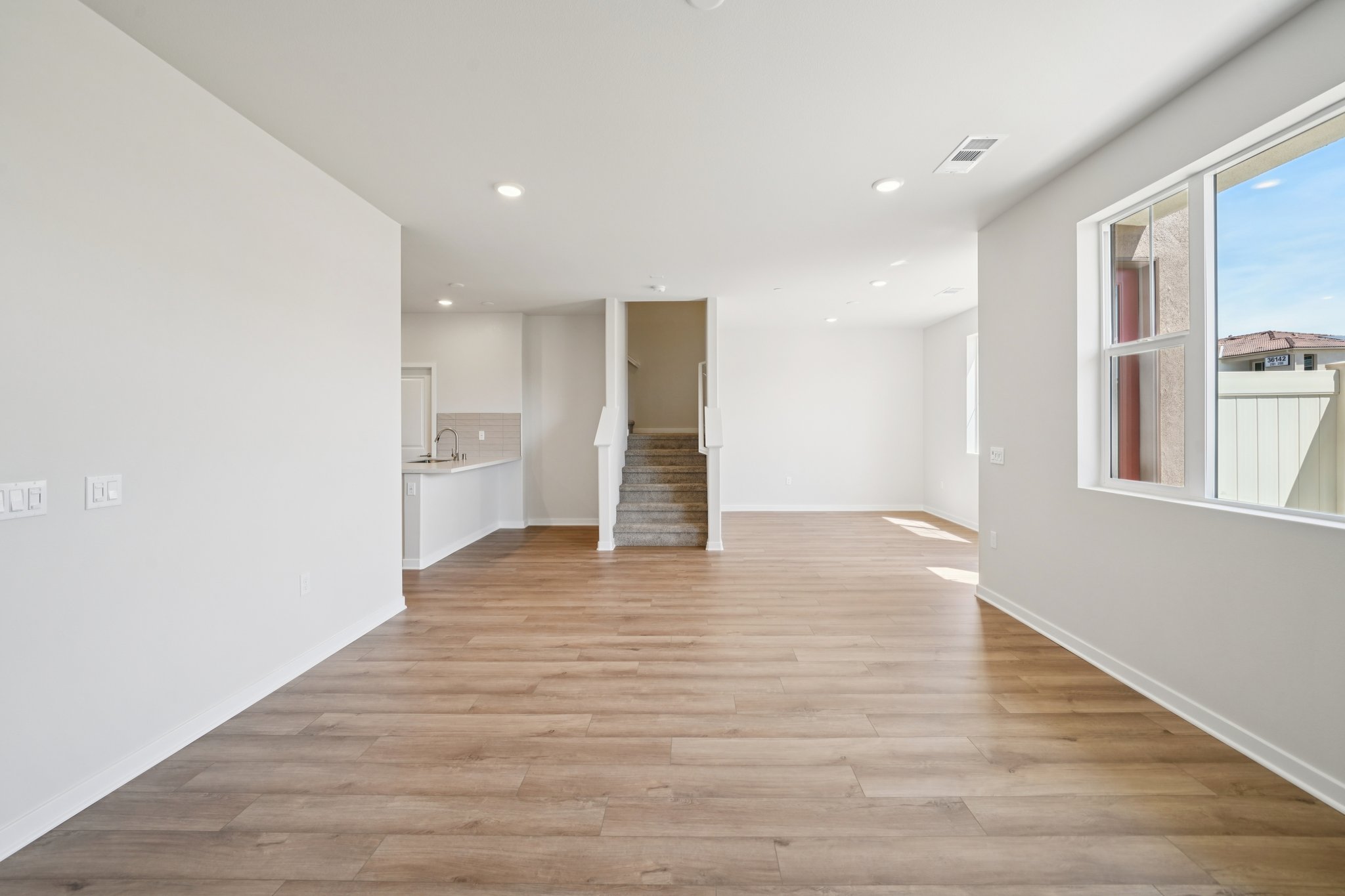 A large empty room with a wood floor.