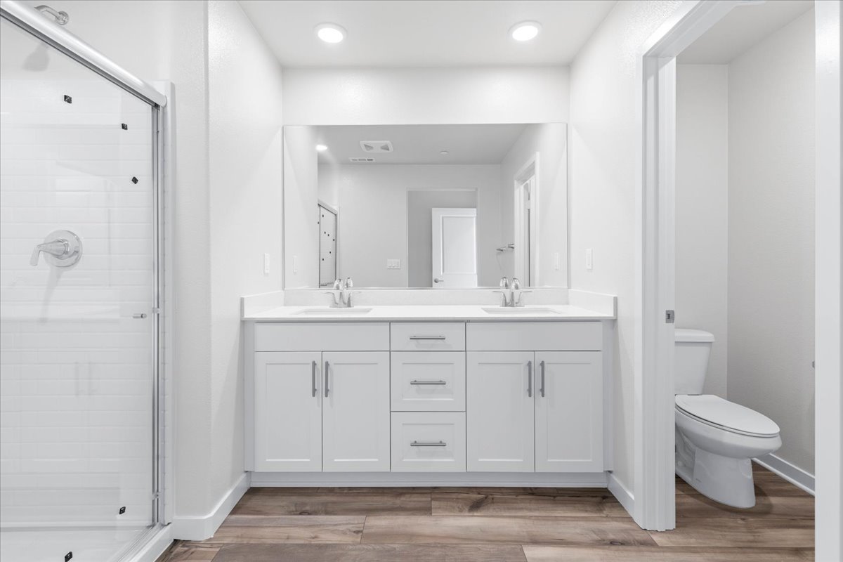 A bathroom with white cabinets.