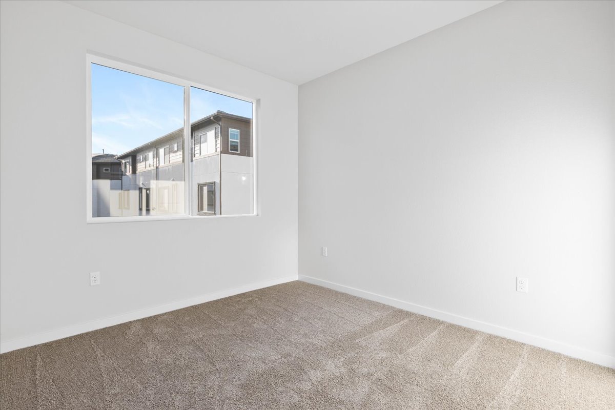 A room with a window and a carpet.