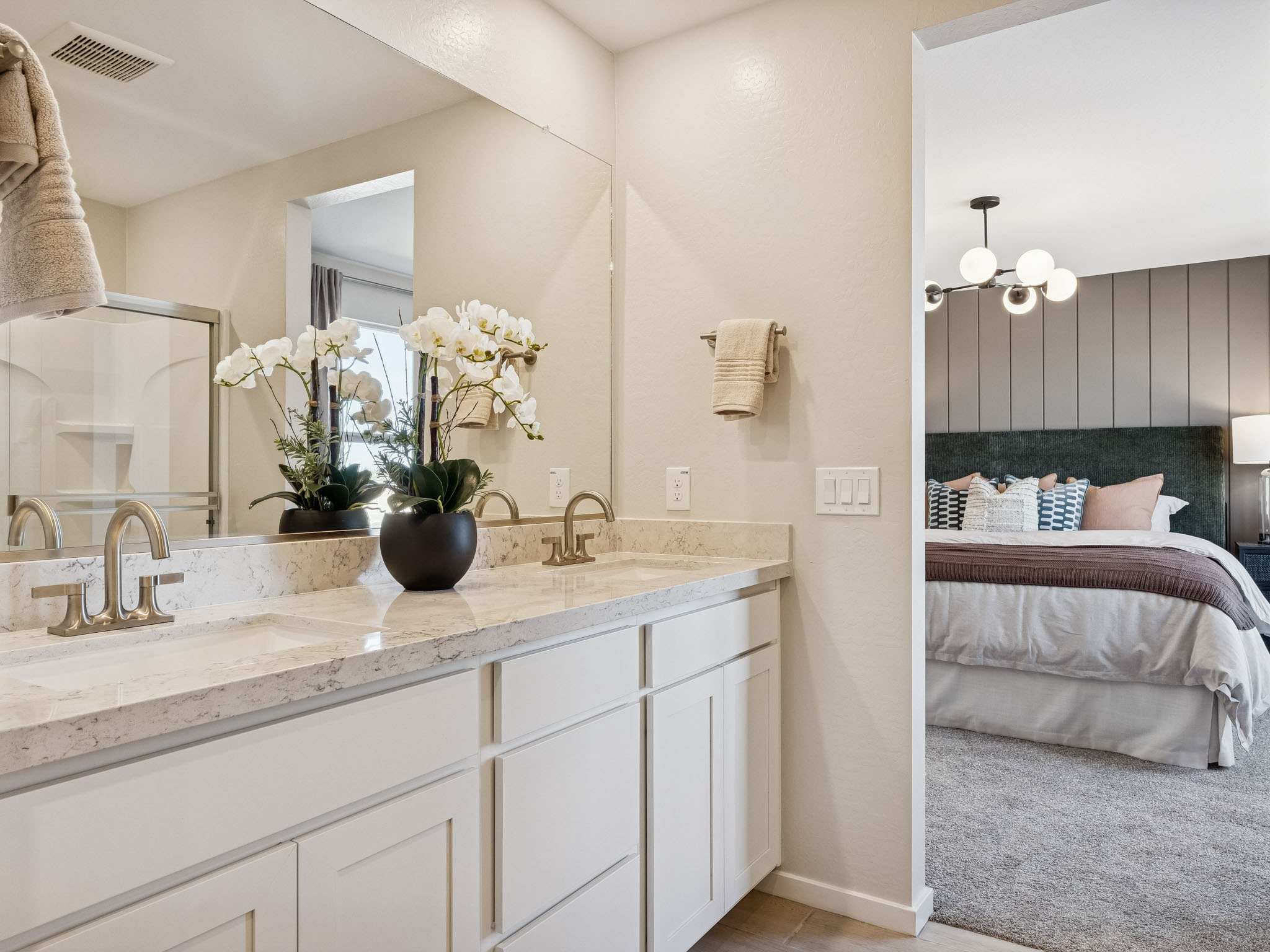 A bathroom with a tub sink and mirror.