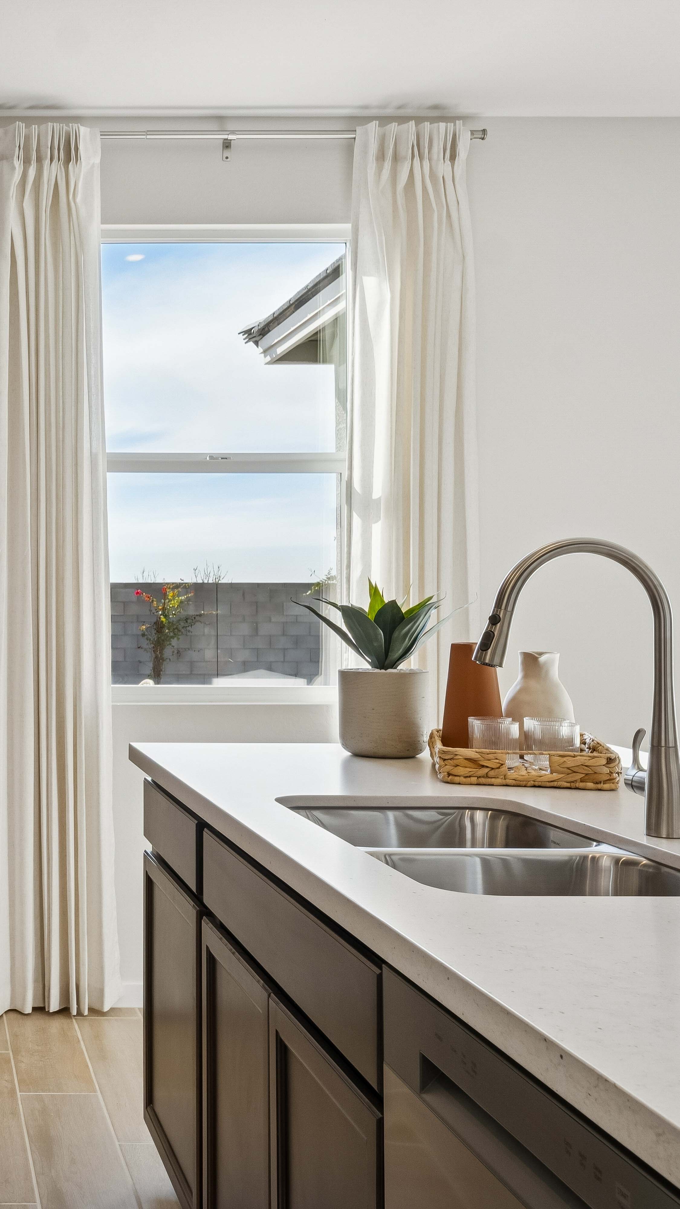 Kitchen island with deep espresso cabinets overlooking the backyard North Copper Canyon Ridge new construction homes for sale in surprise az find your dream home
