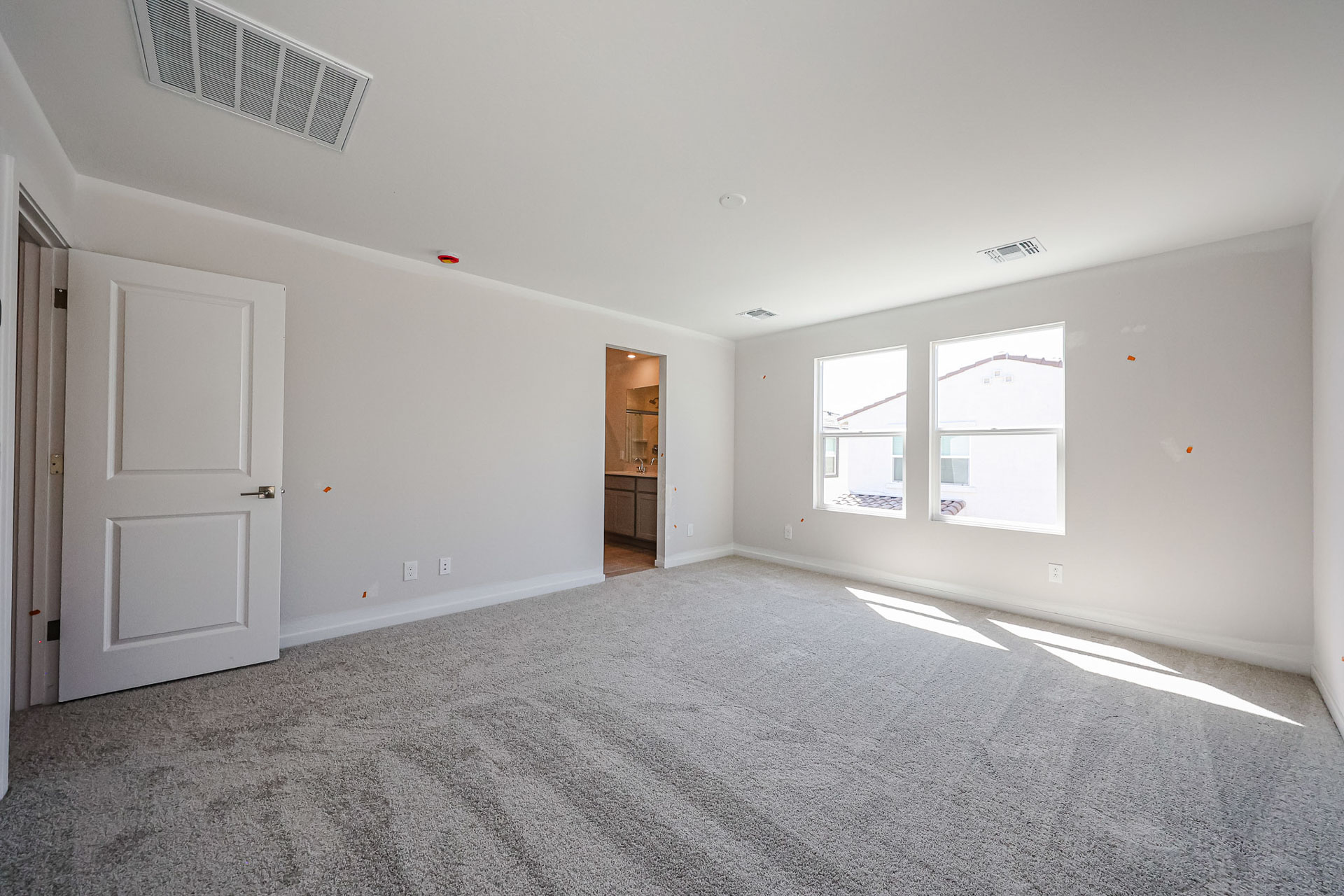 A room with white walls and a door.