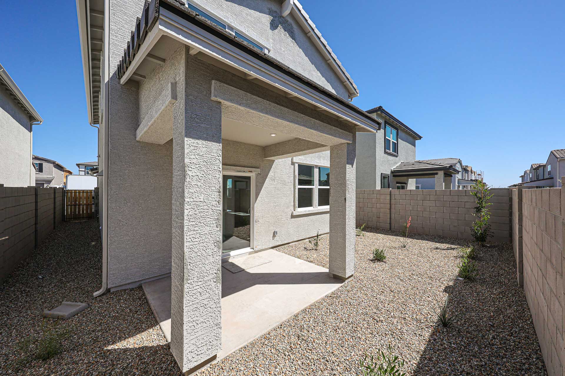 A house with a stone patio.
