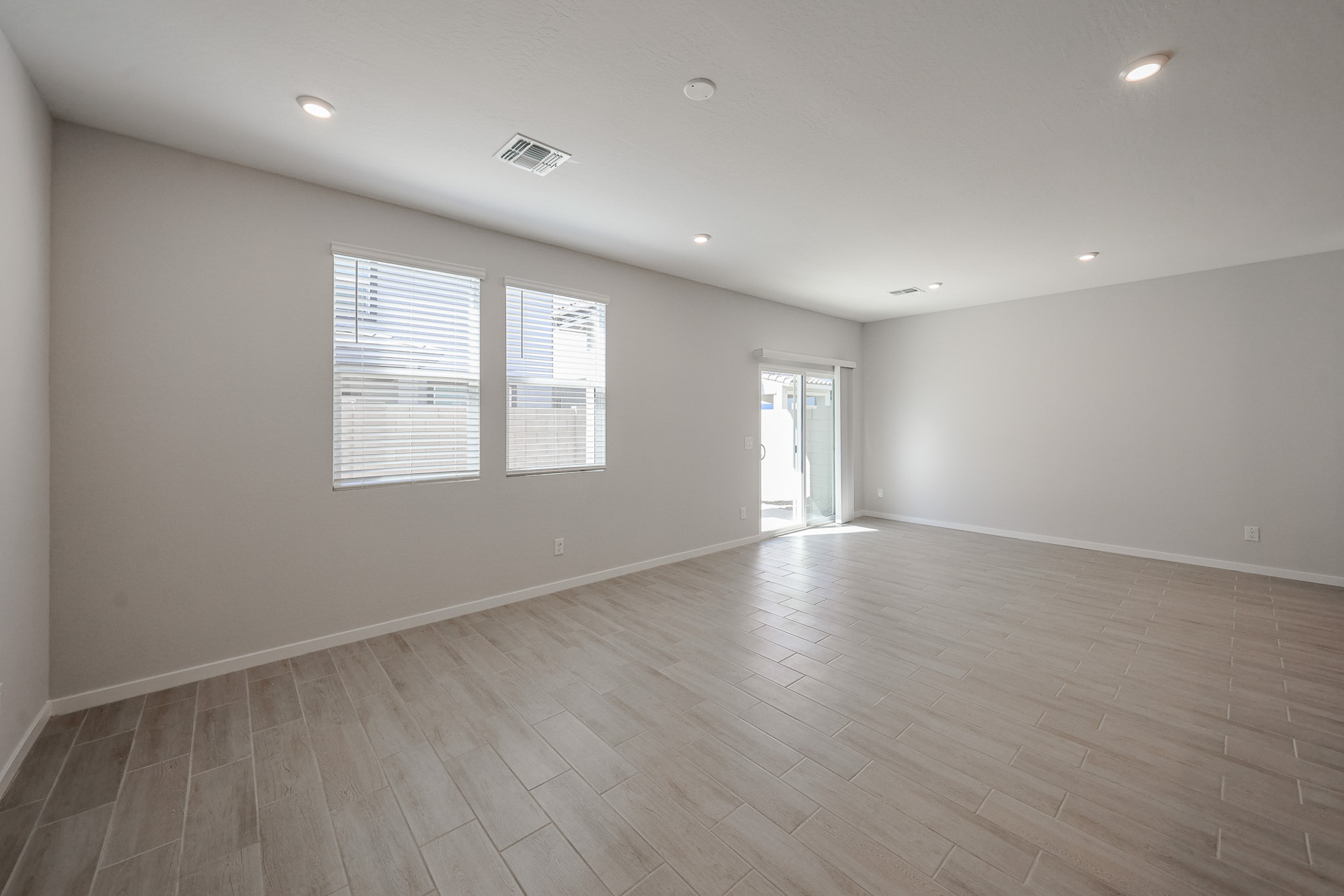 A room with a wood floor and white walls.