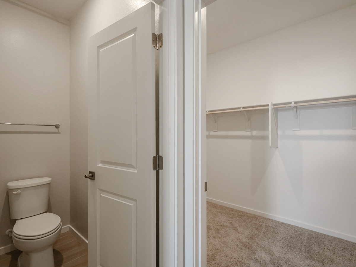 A bathroom with a toilet and bathtub.