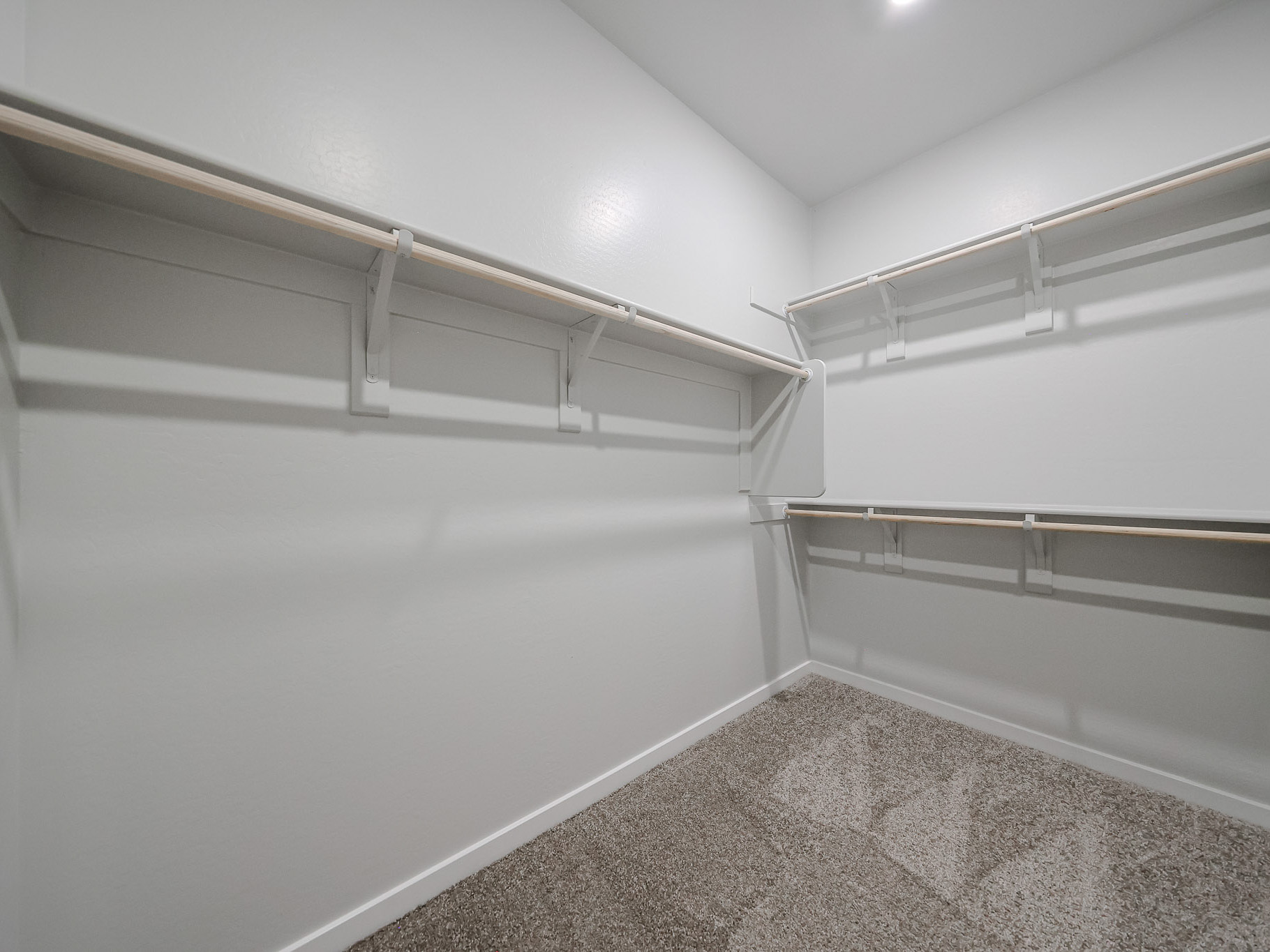 A white room with a metal railing.