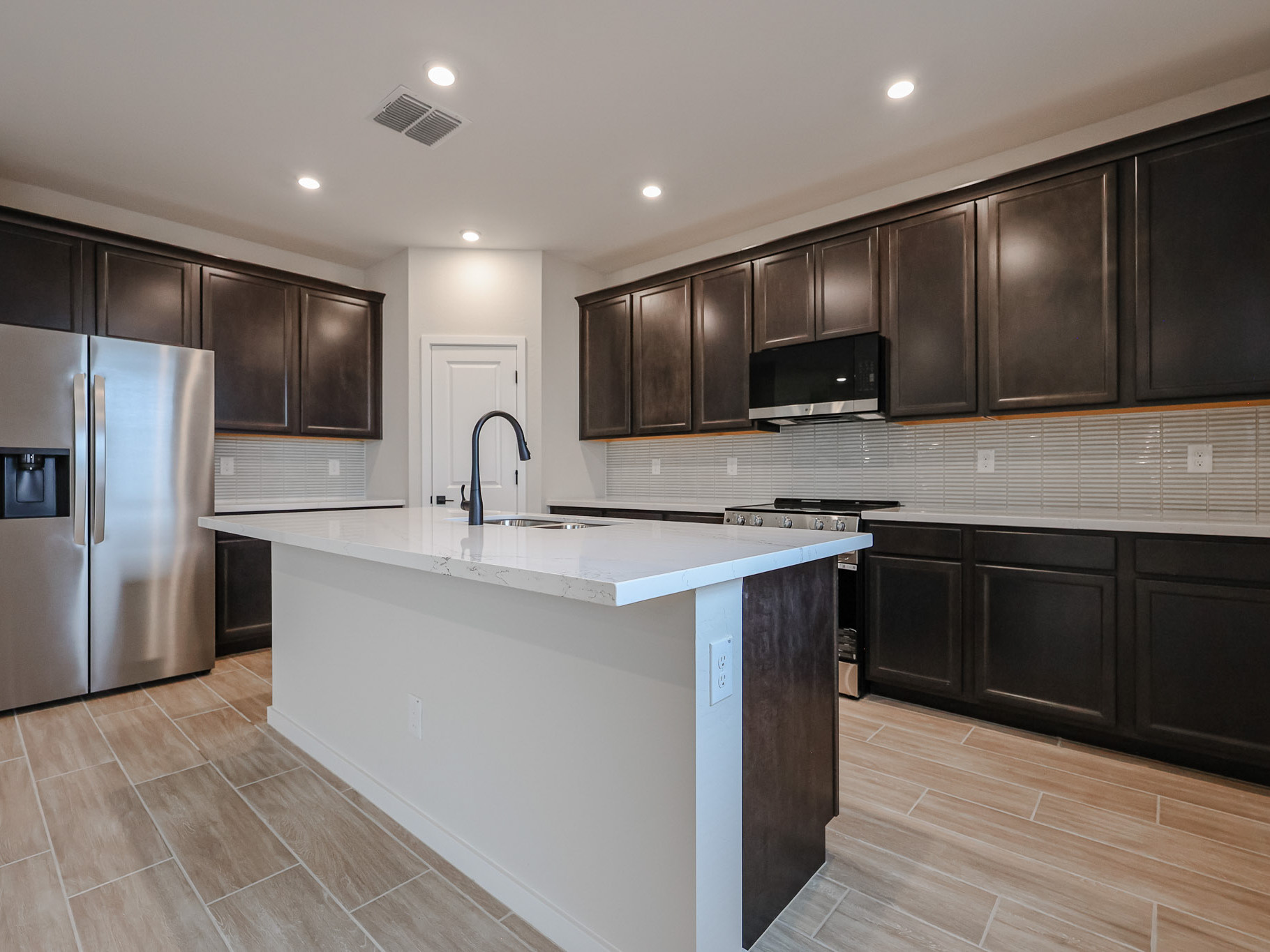 A kitchen with black cabinets.
