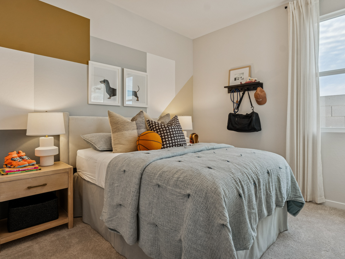 A bedroom with a bed and a lamp.