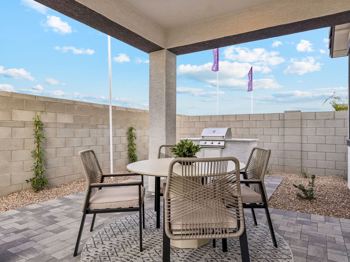 A patio with a table and chairs.