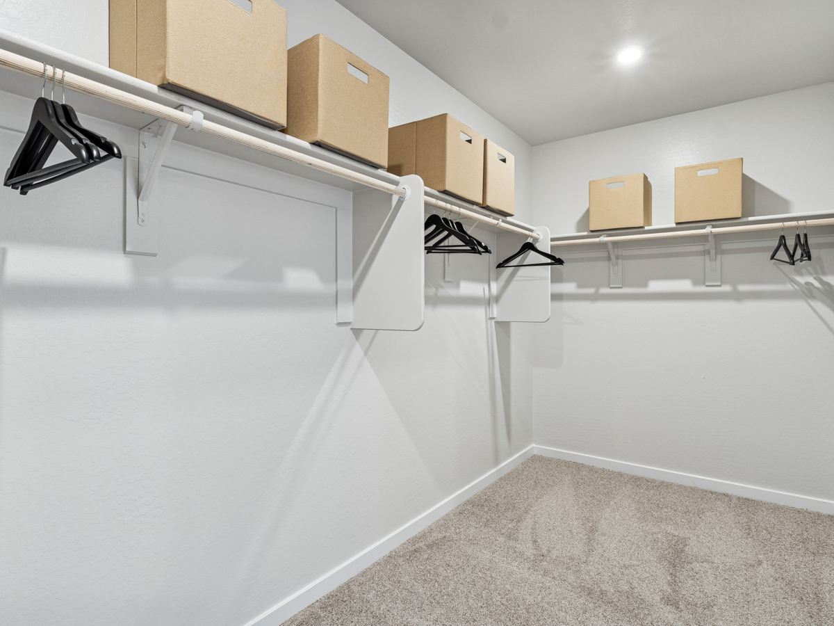 A white staircase with boxes on the top.